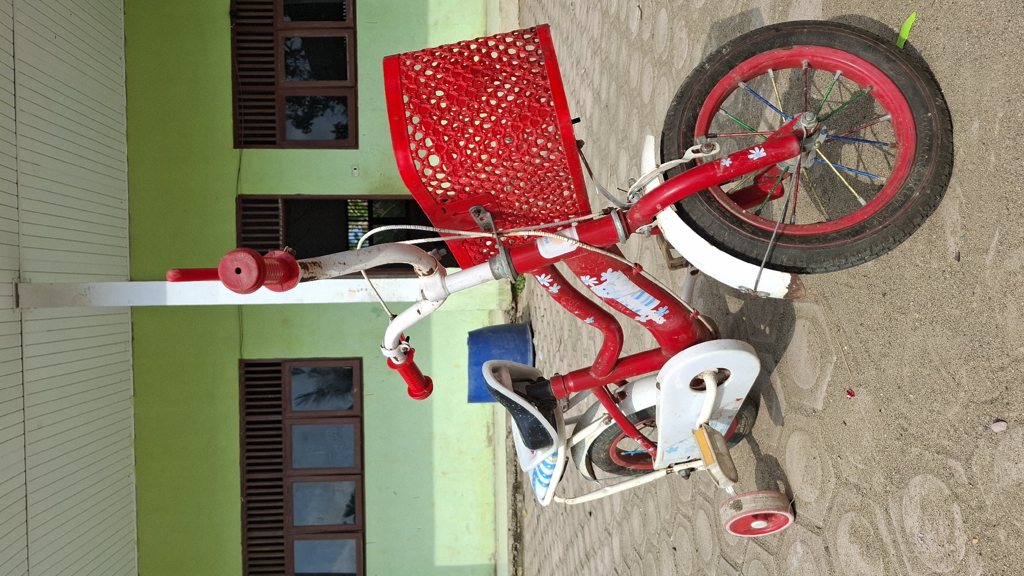 Red kids' bike and a quiet morning sit-down in Grong-grong