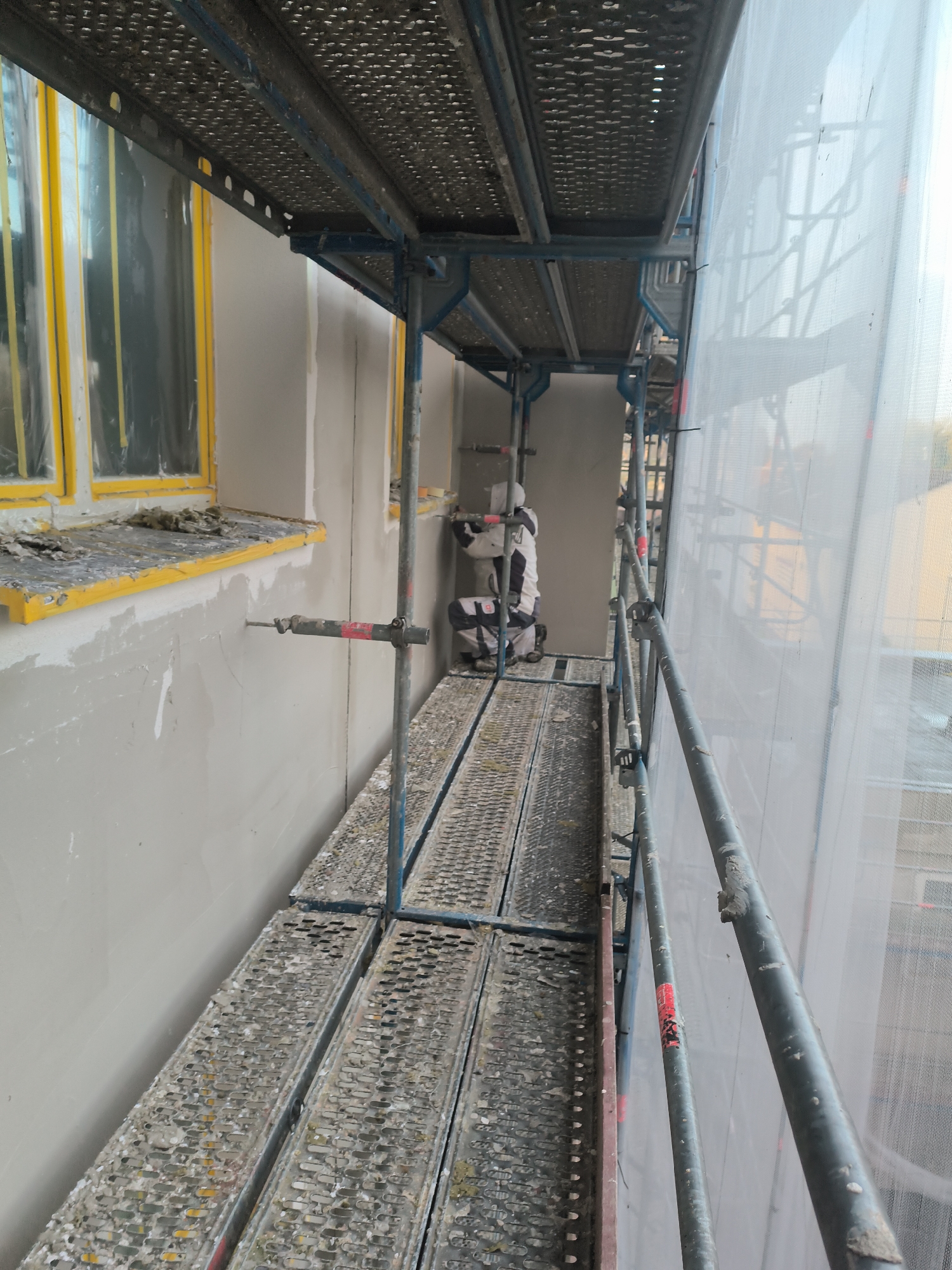 Building renovation underway in Essen with scaffolding and workers
