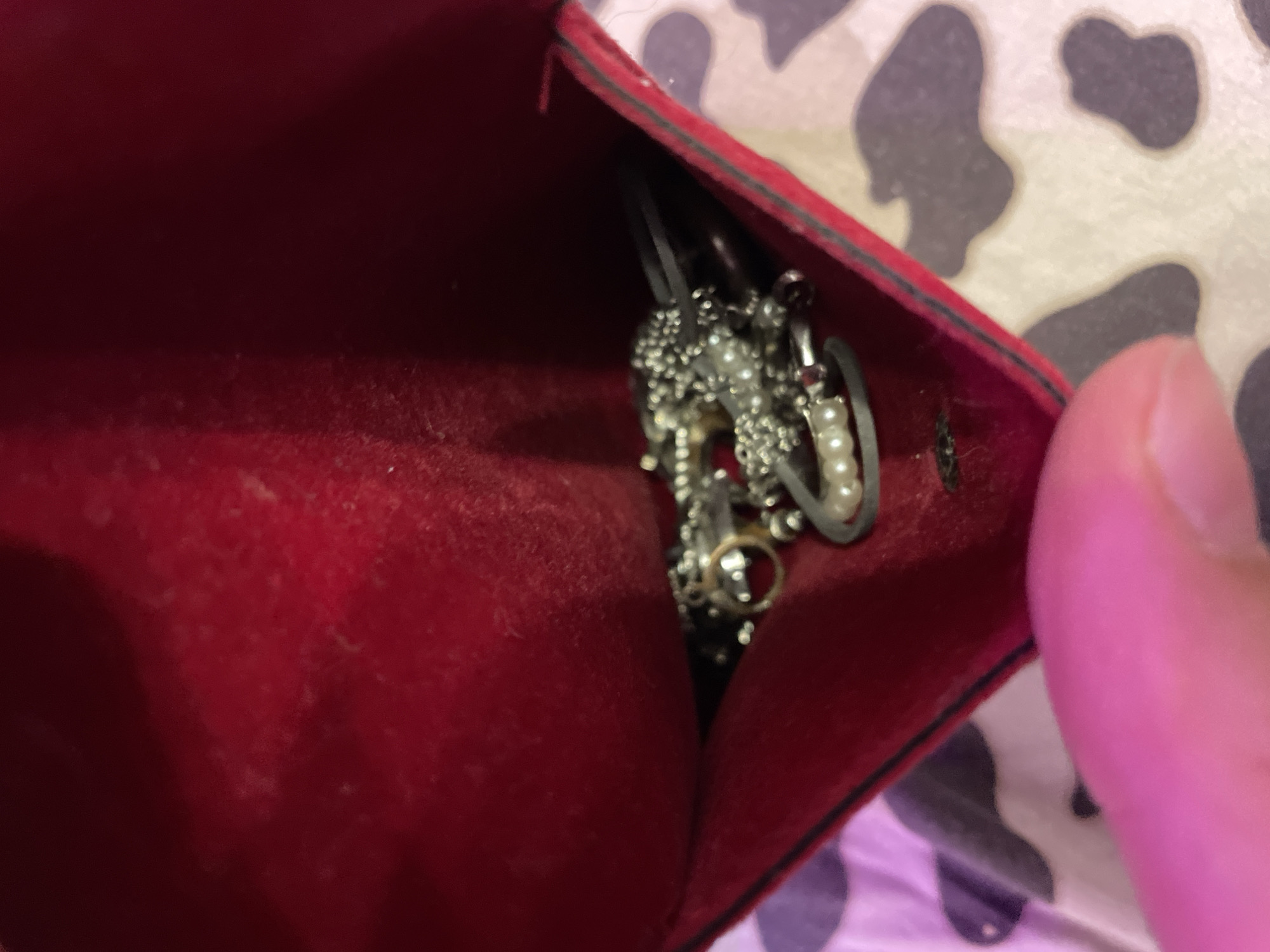 Person examines silver jewelry collection near Lake Ladoga