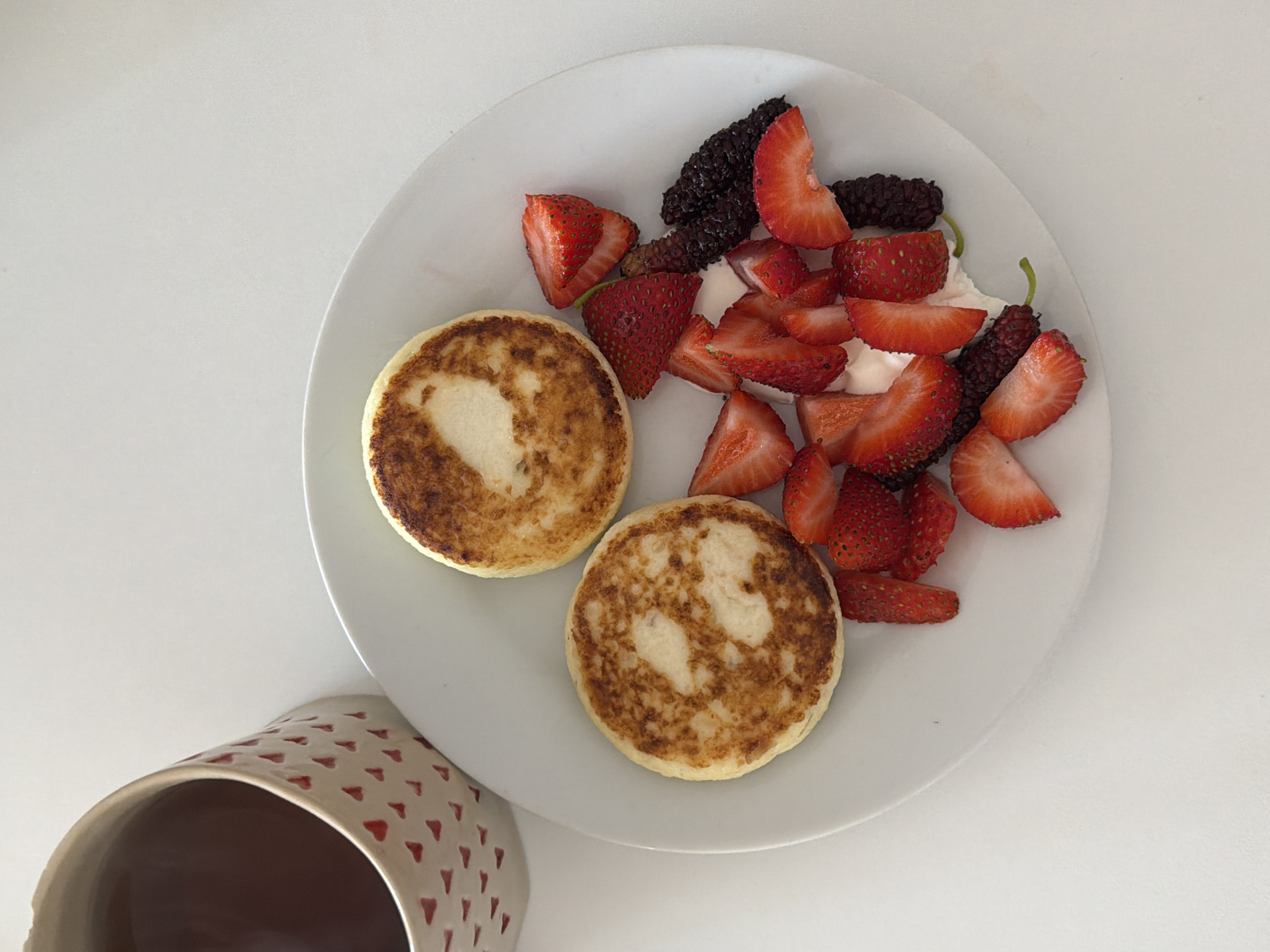 Tel Aviv breakfast photo shows cottage cheese pancakes with berries