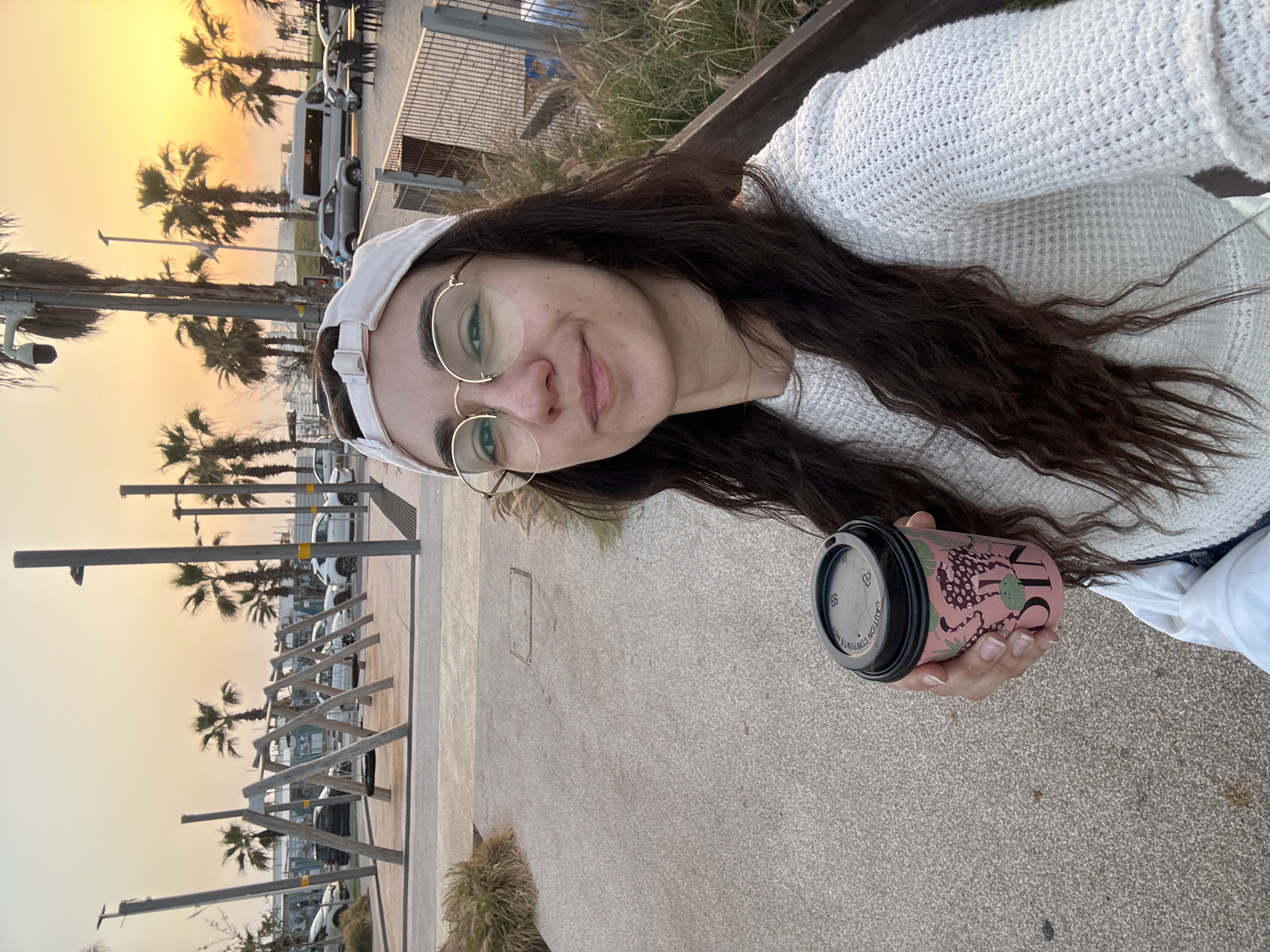 Woman takes sunset selfie in Bat Yam, Israel