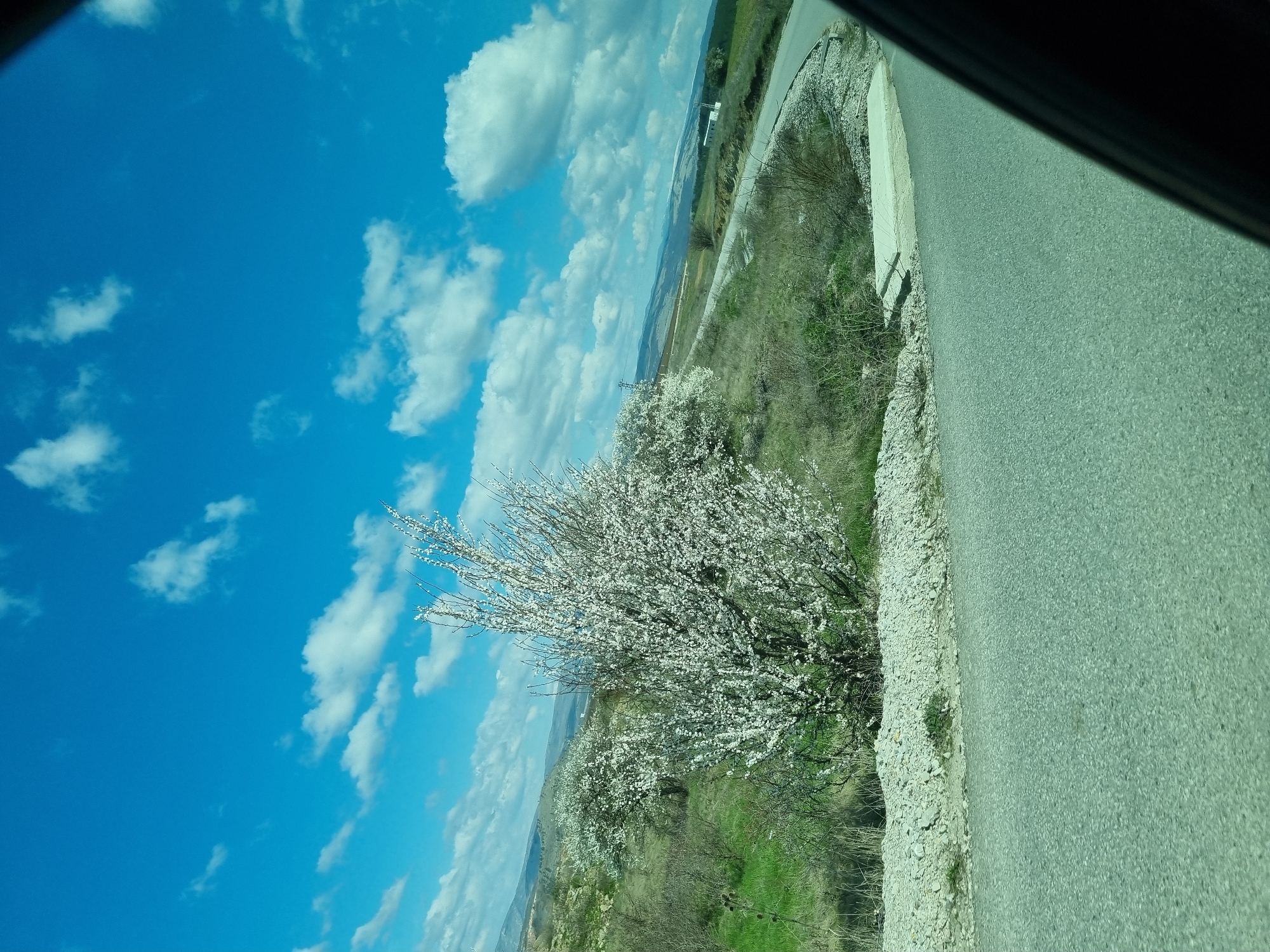 Vehicle travels through rural Bulgarian countryside near Slivnitsa