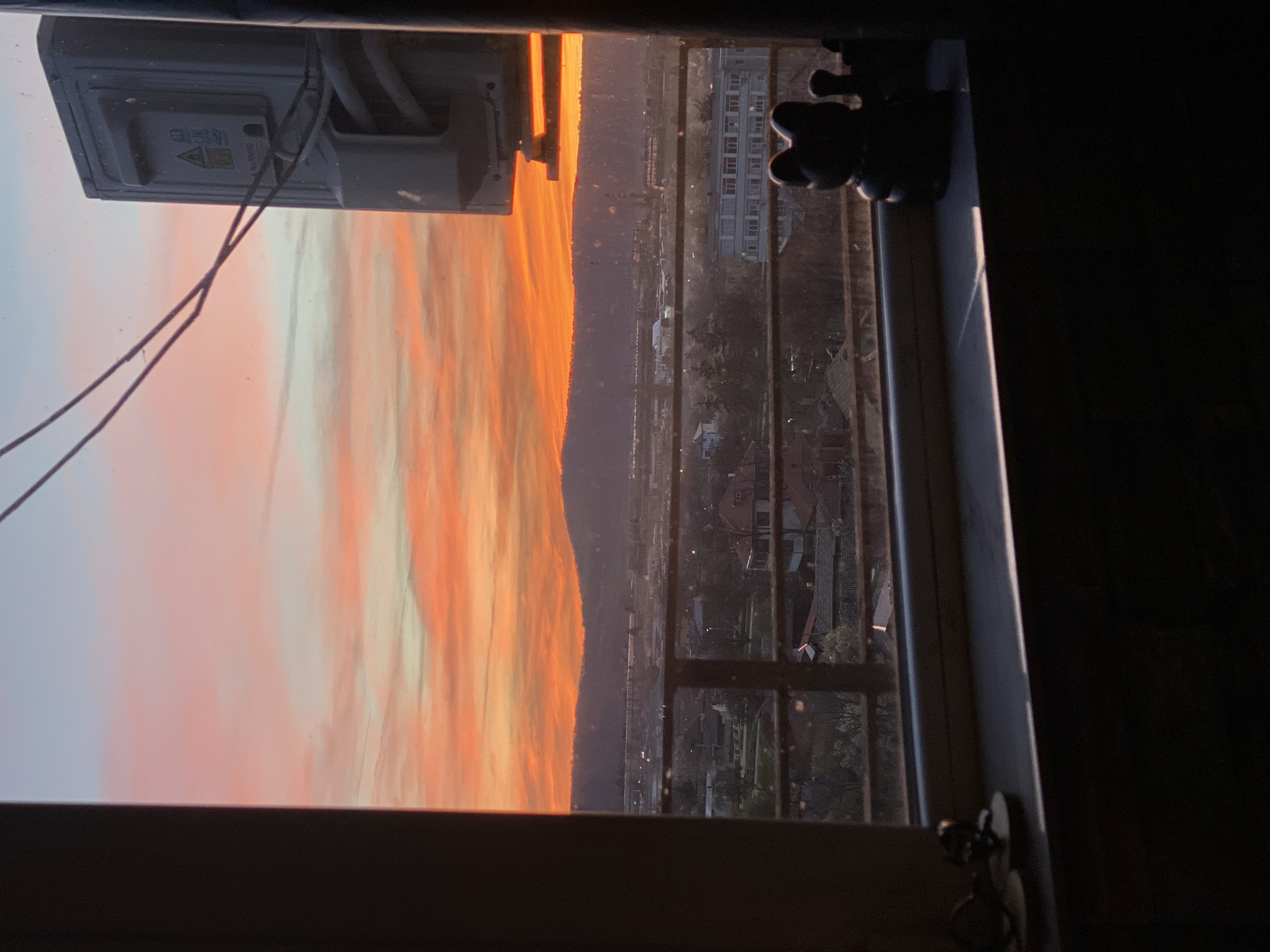 Sunset viewed over Targovishte cityscape from window