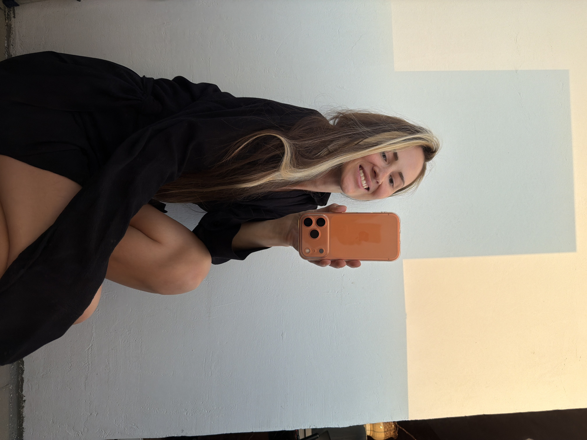 Woman takes selfies with orange phone in Khimki