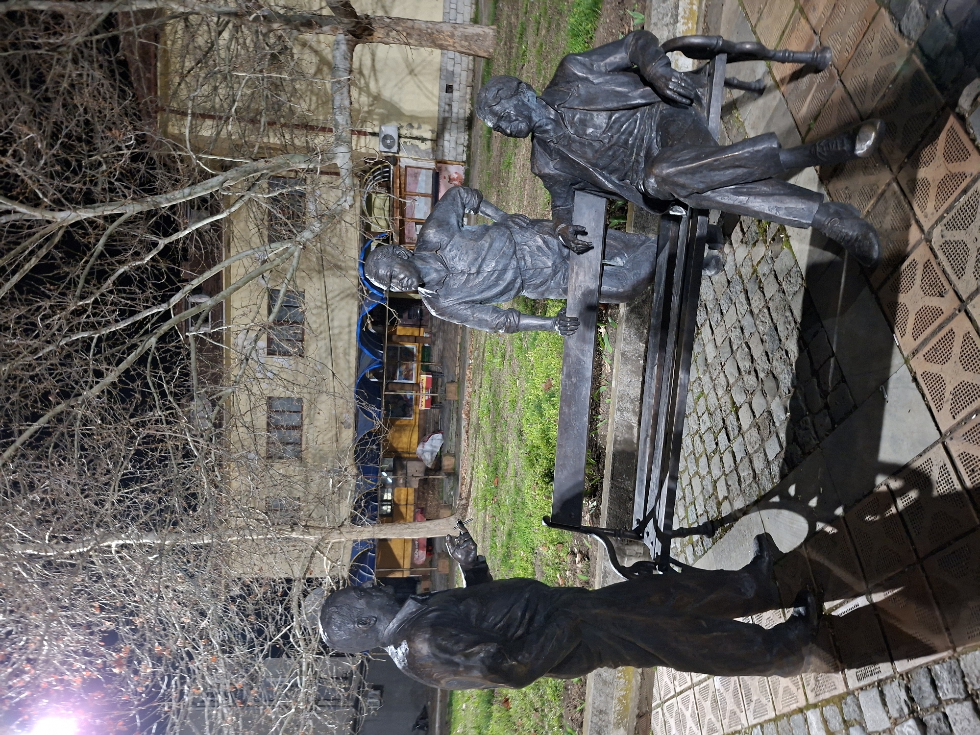 Visitors pose with bronze statues in Levski park
