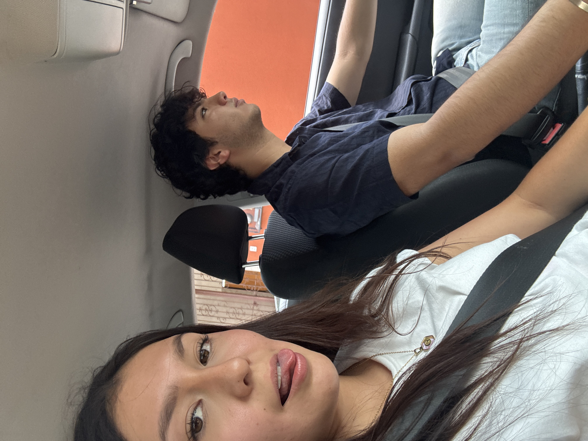 Two passengers travel by car in Oaxaca City