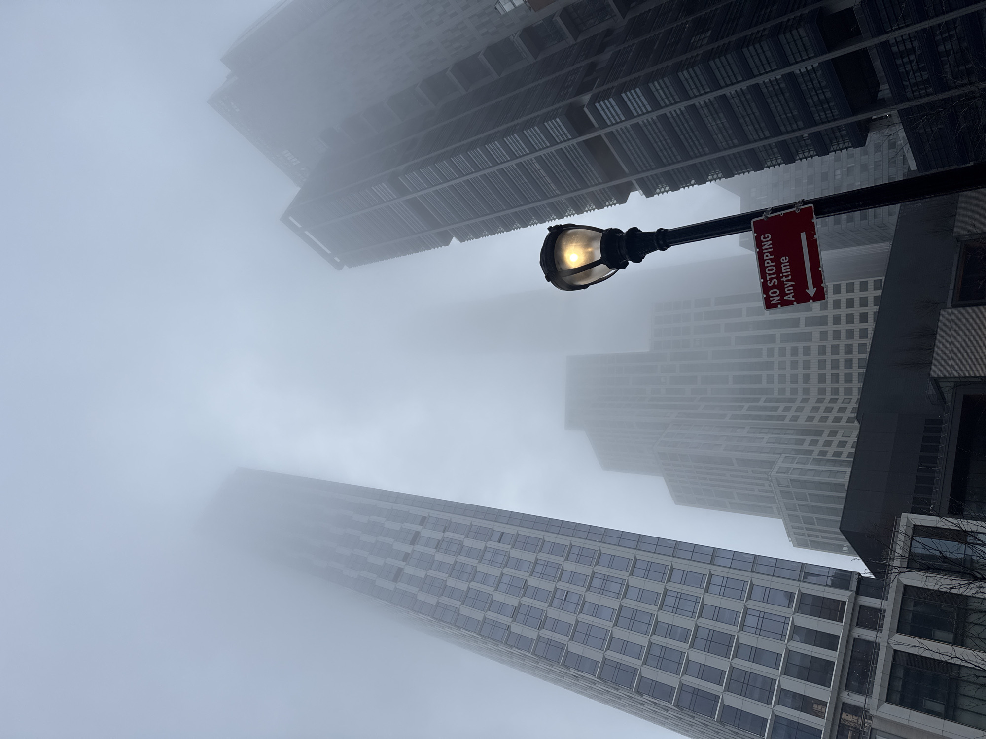 Dense fog blankets New York City streets, obscuring buildings