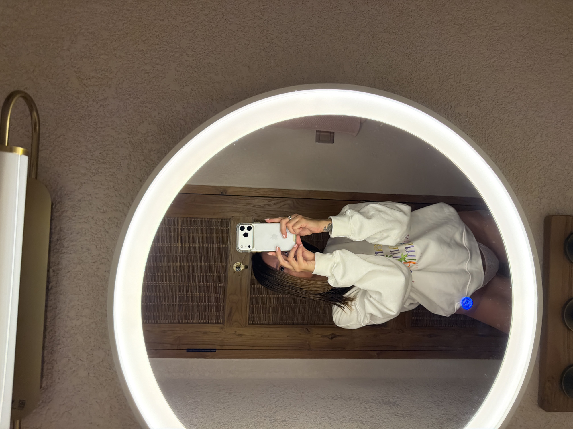 Woman takes bathroom selfies in illuminated mirror in Indonesia