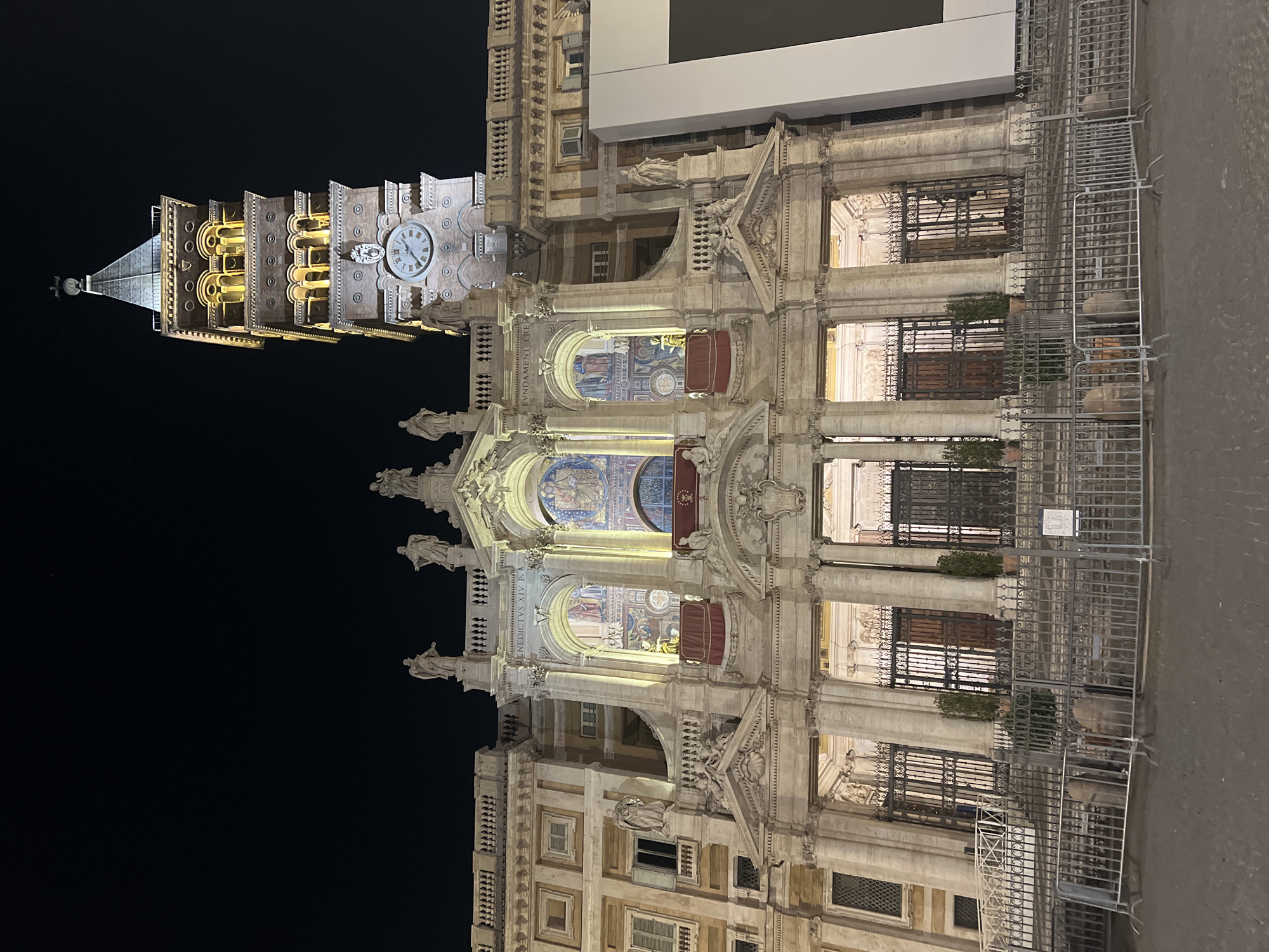 Historic Rome basilica and bell tower illuminated at night