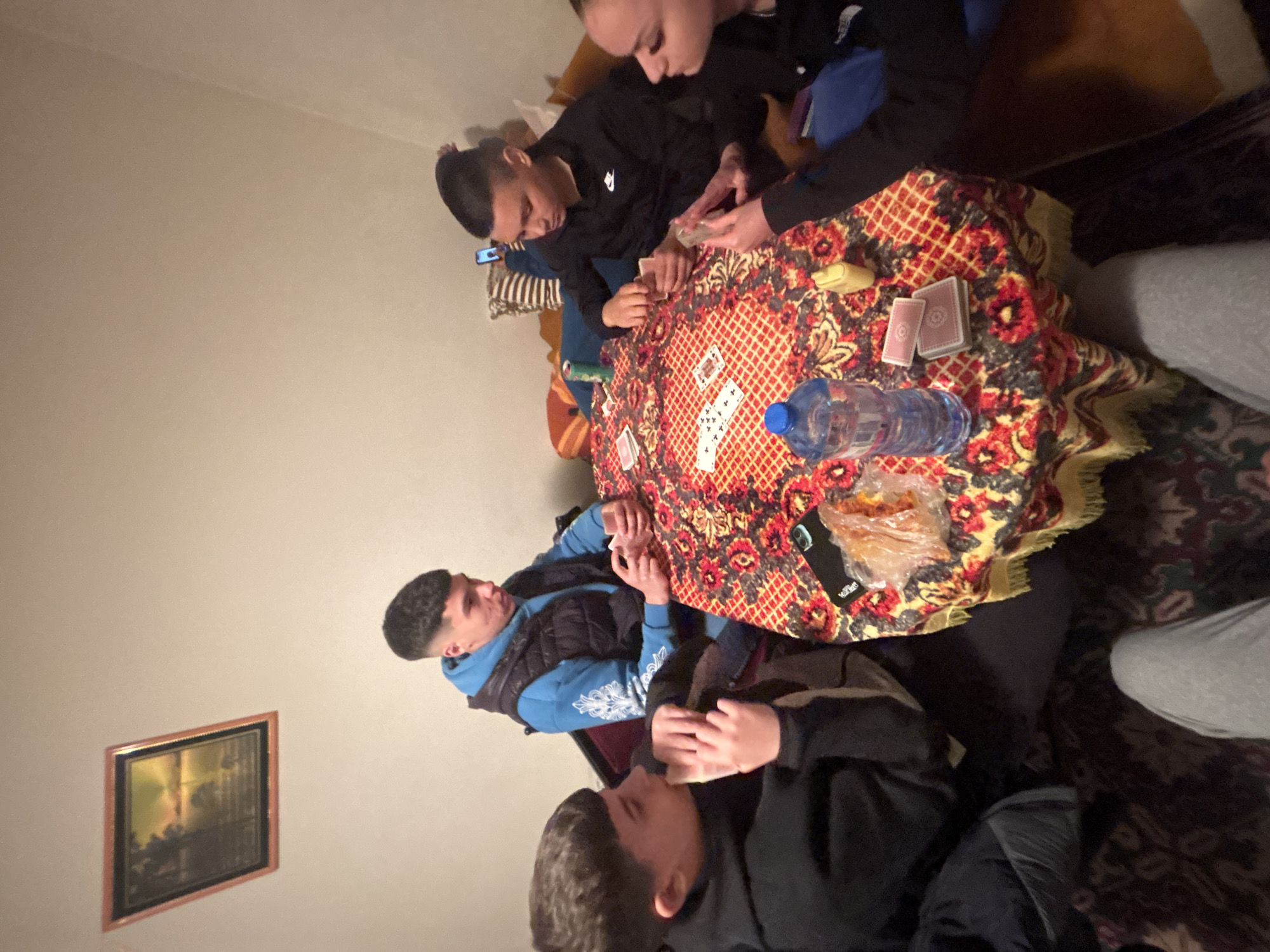 Young people play cards in Bulgarian living room