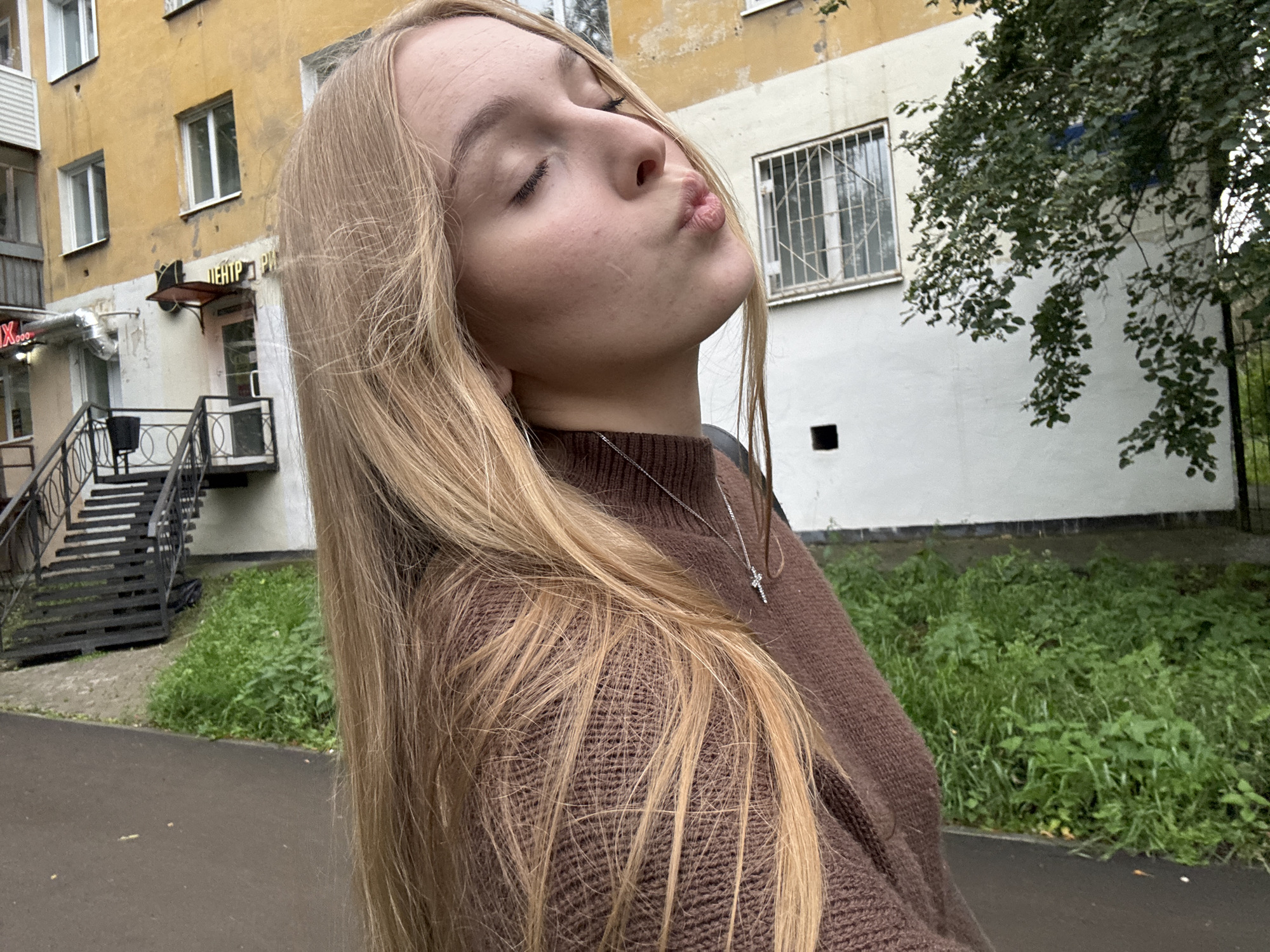 Selfie series in a Perm park, brown sweater and cross necklace