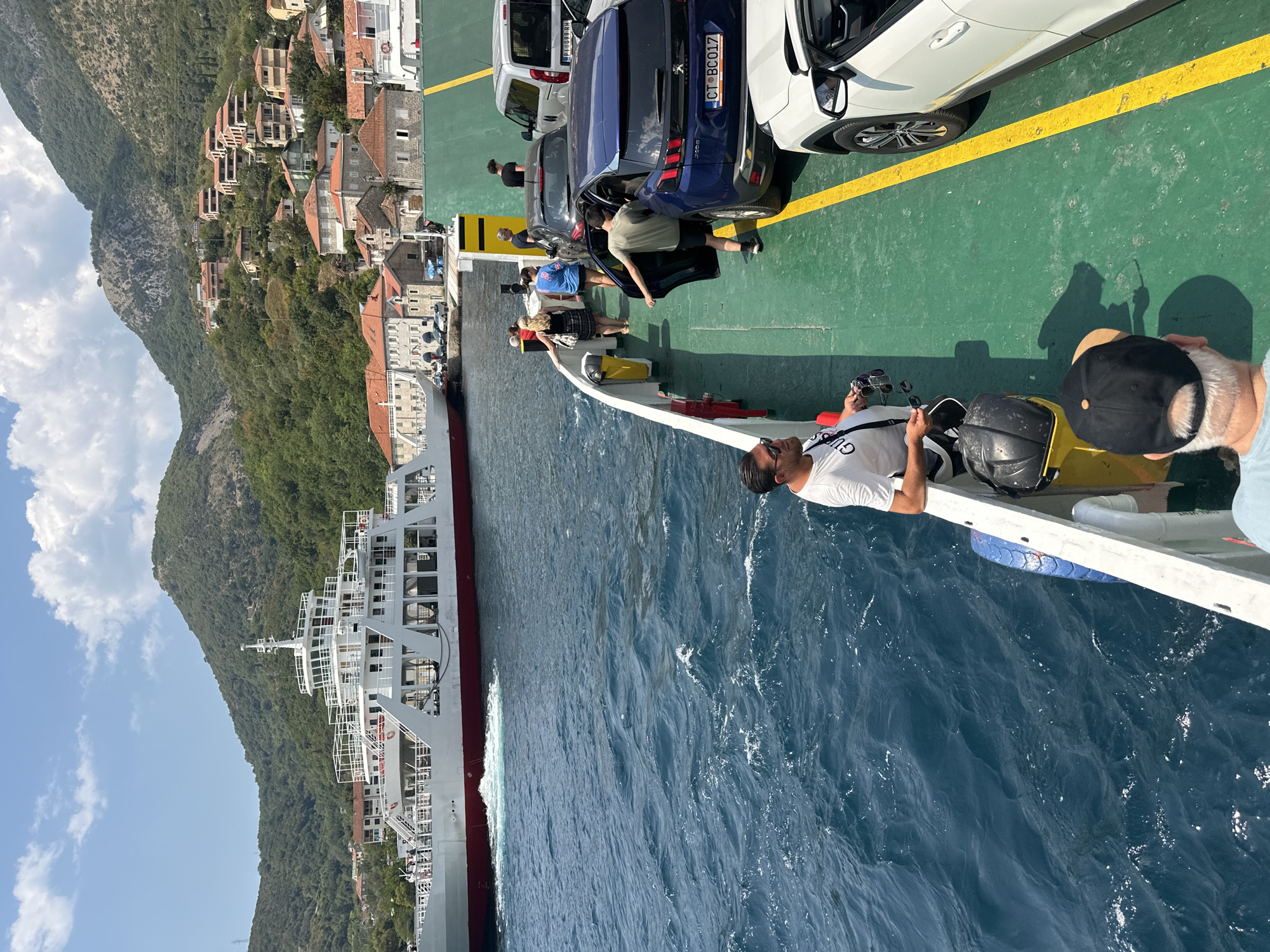 Ferry crossing the Bay of Kotor, cars and passengers on deck