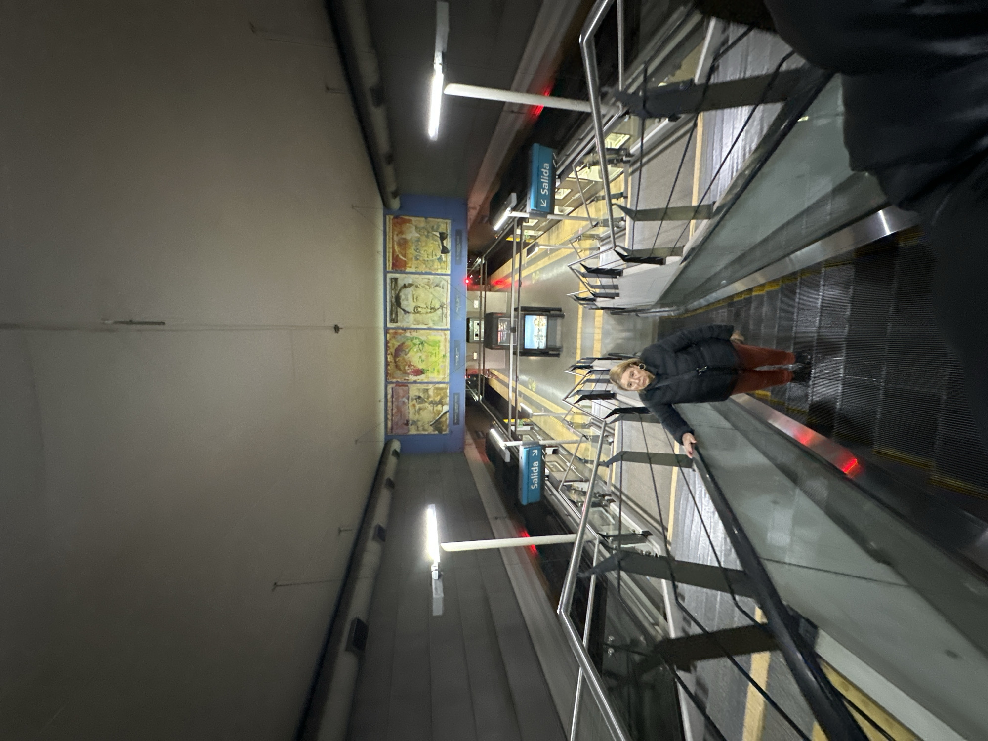 Woman rides escalator in Buenos Aires subway system