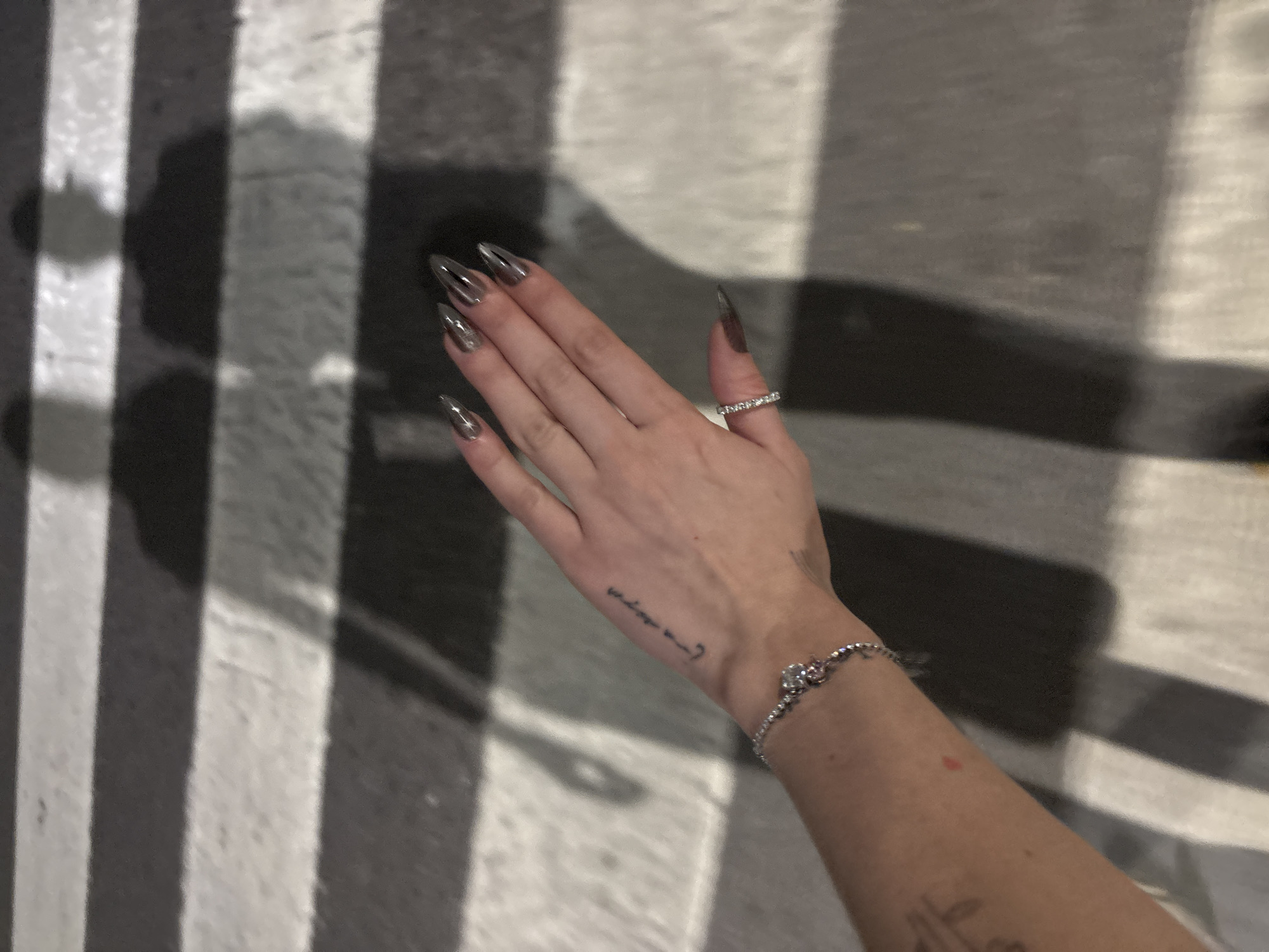 Manicured stiletto nails and jewelry displayed in Buenos Aires