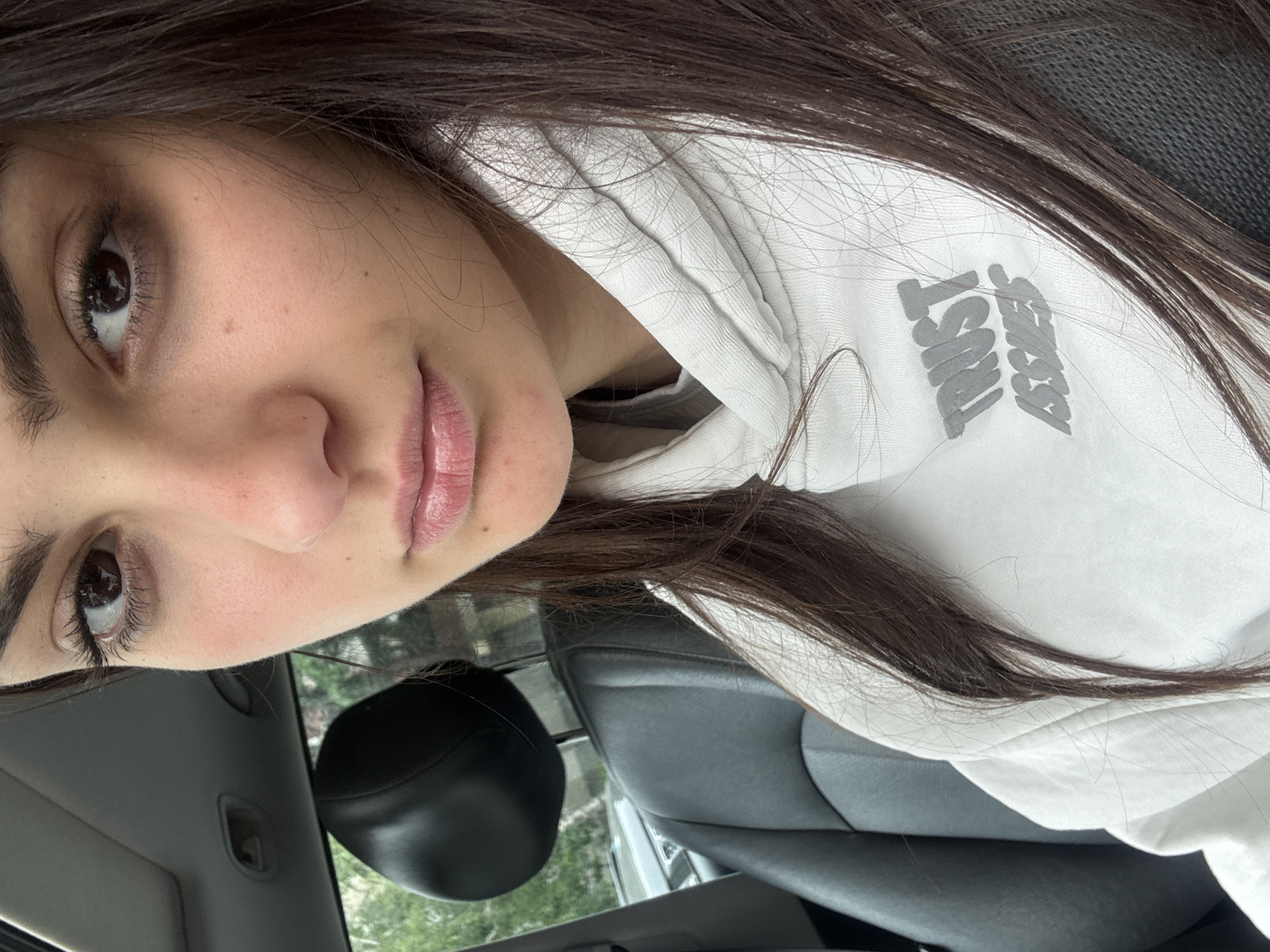 Woman in "Trust Issue" hoodie photographed in car, Blagoevgrad