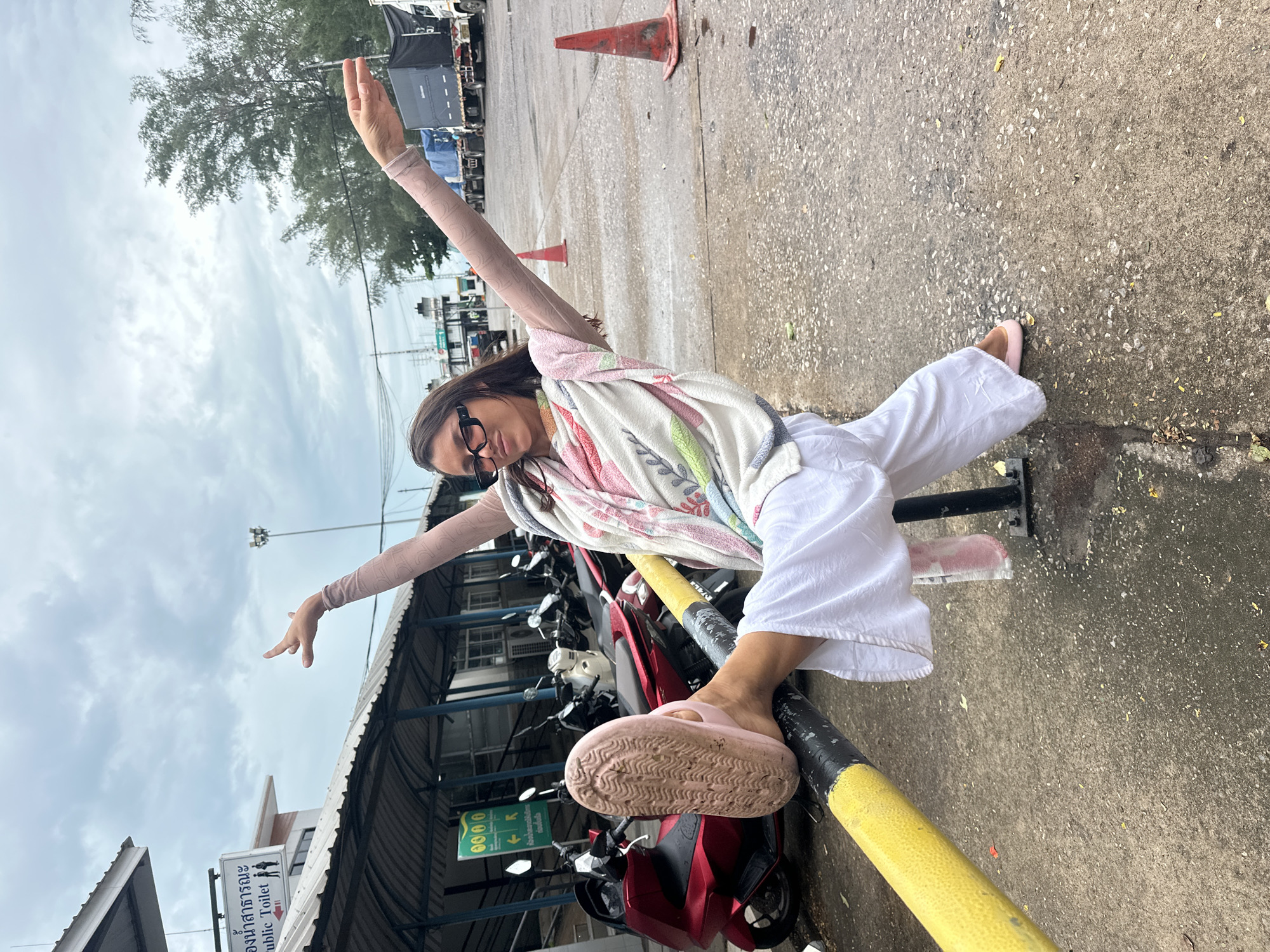 Casual photo stop near a public restroom in Thailand