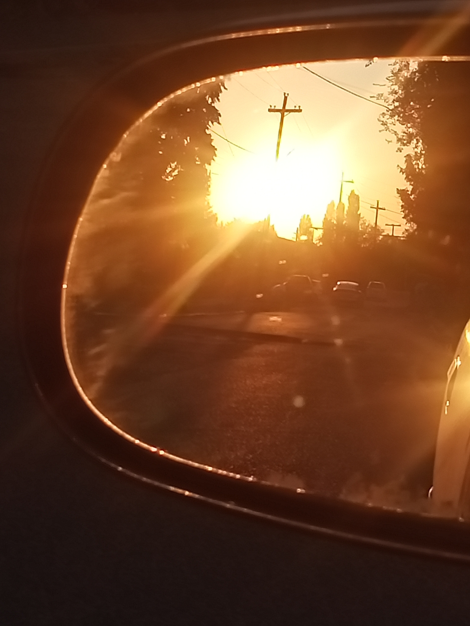 Sunset glare and golden light off a parked car in Sokuluk