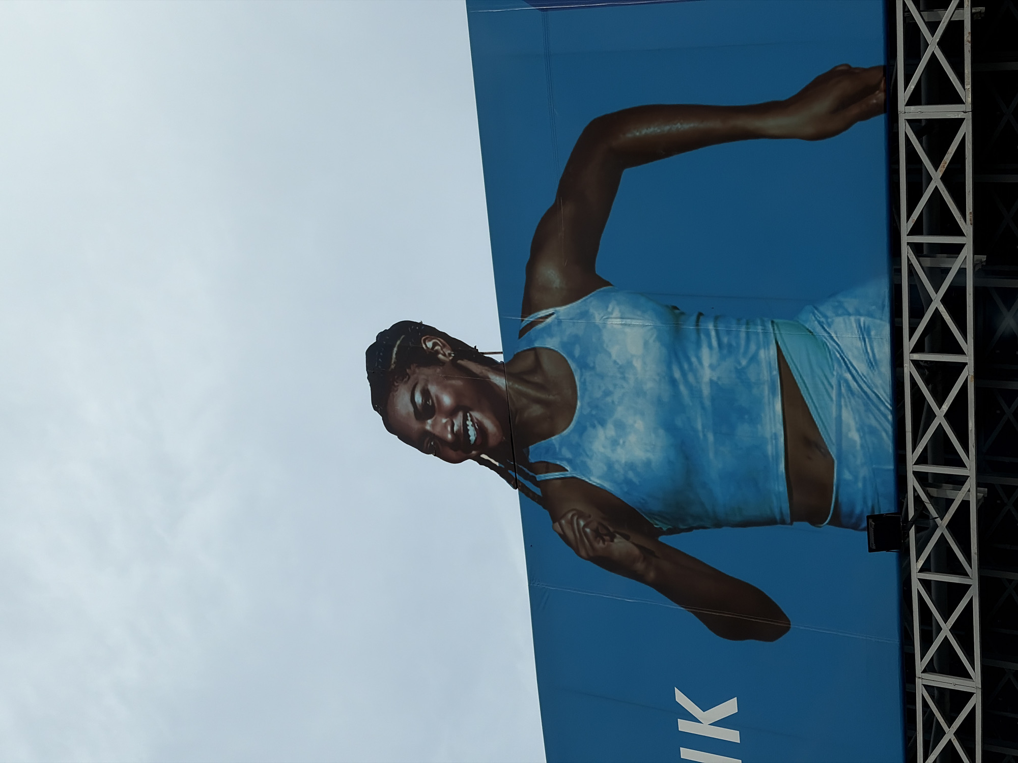Athletic advertisement and modern building observed in Lagos area