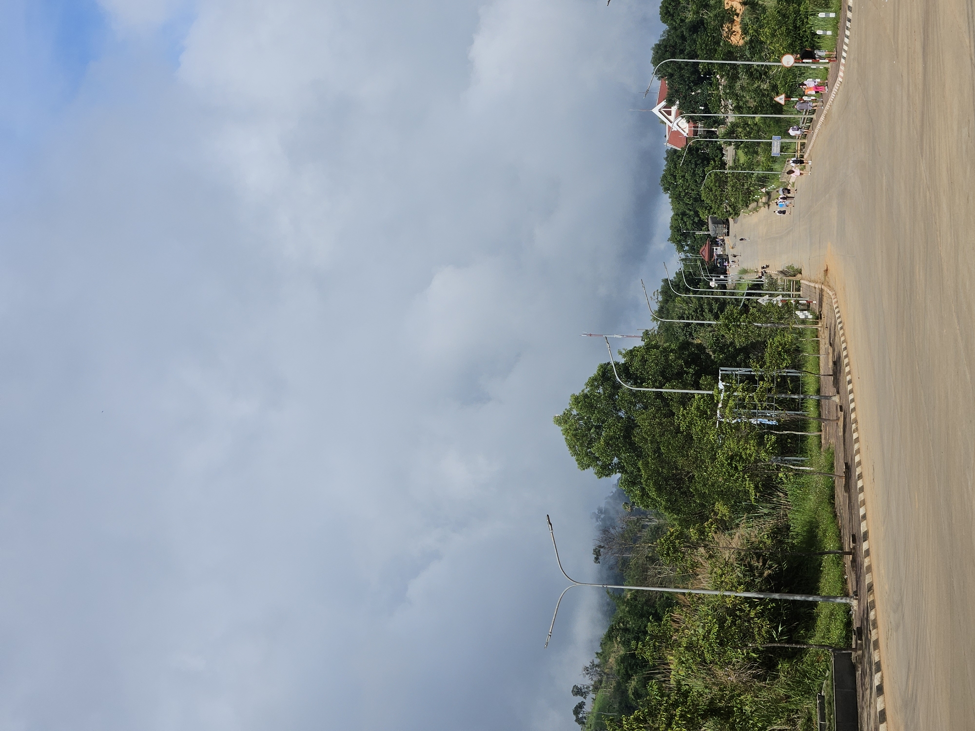 Green hills, red cliffs, and a winding road on the Vietnam-Laos border
