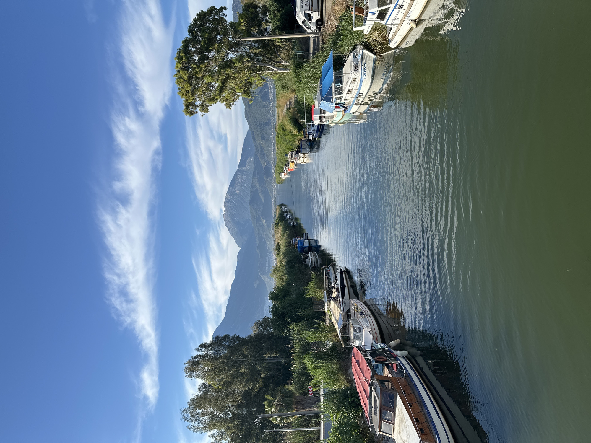 Woman observed on bridge over boat-lined canal in Fethiye