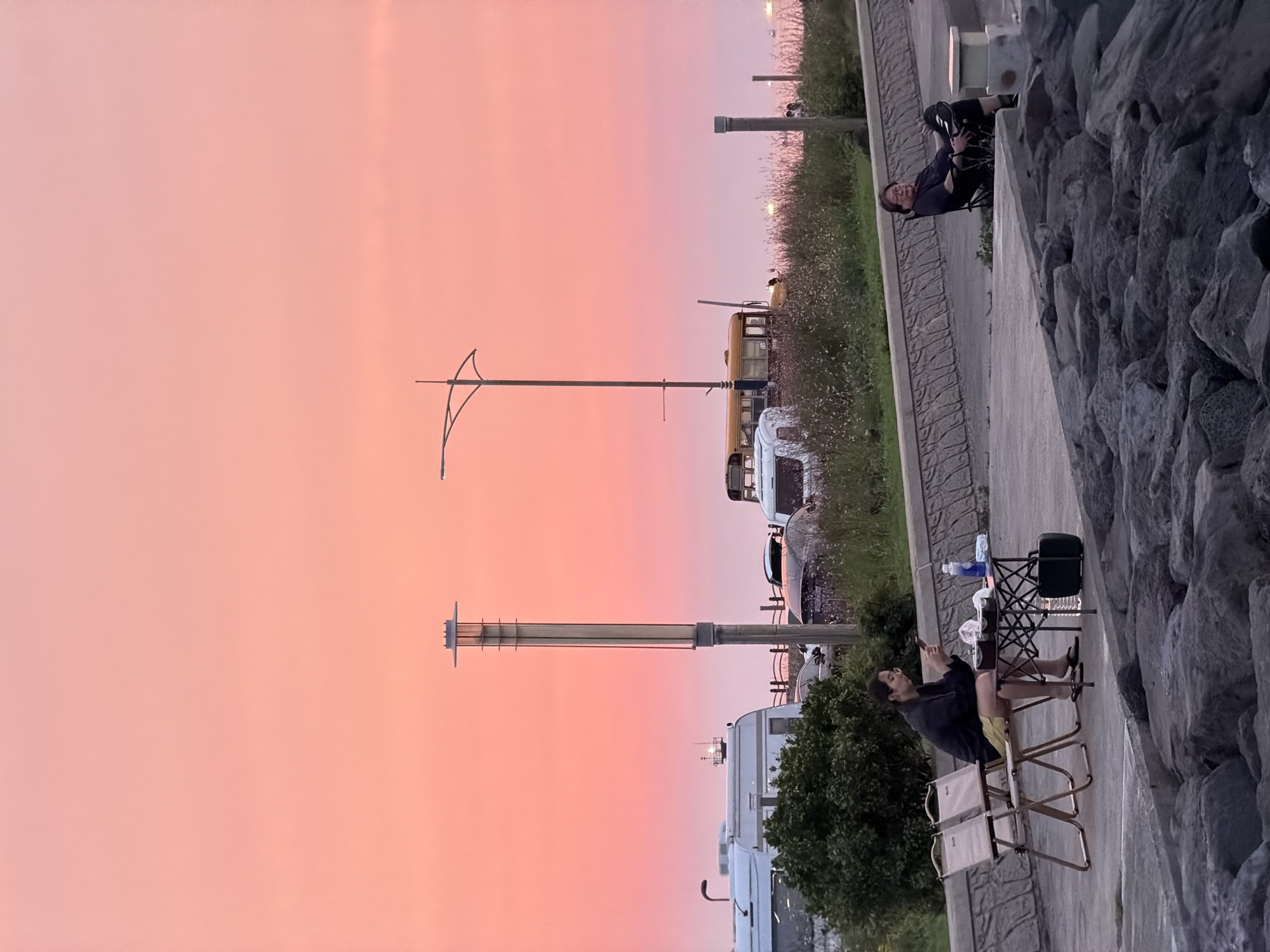 Dusk along Jeju's volcanic coastline, grill lit, sky glowing