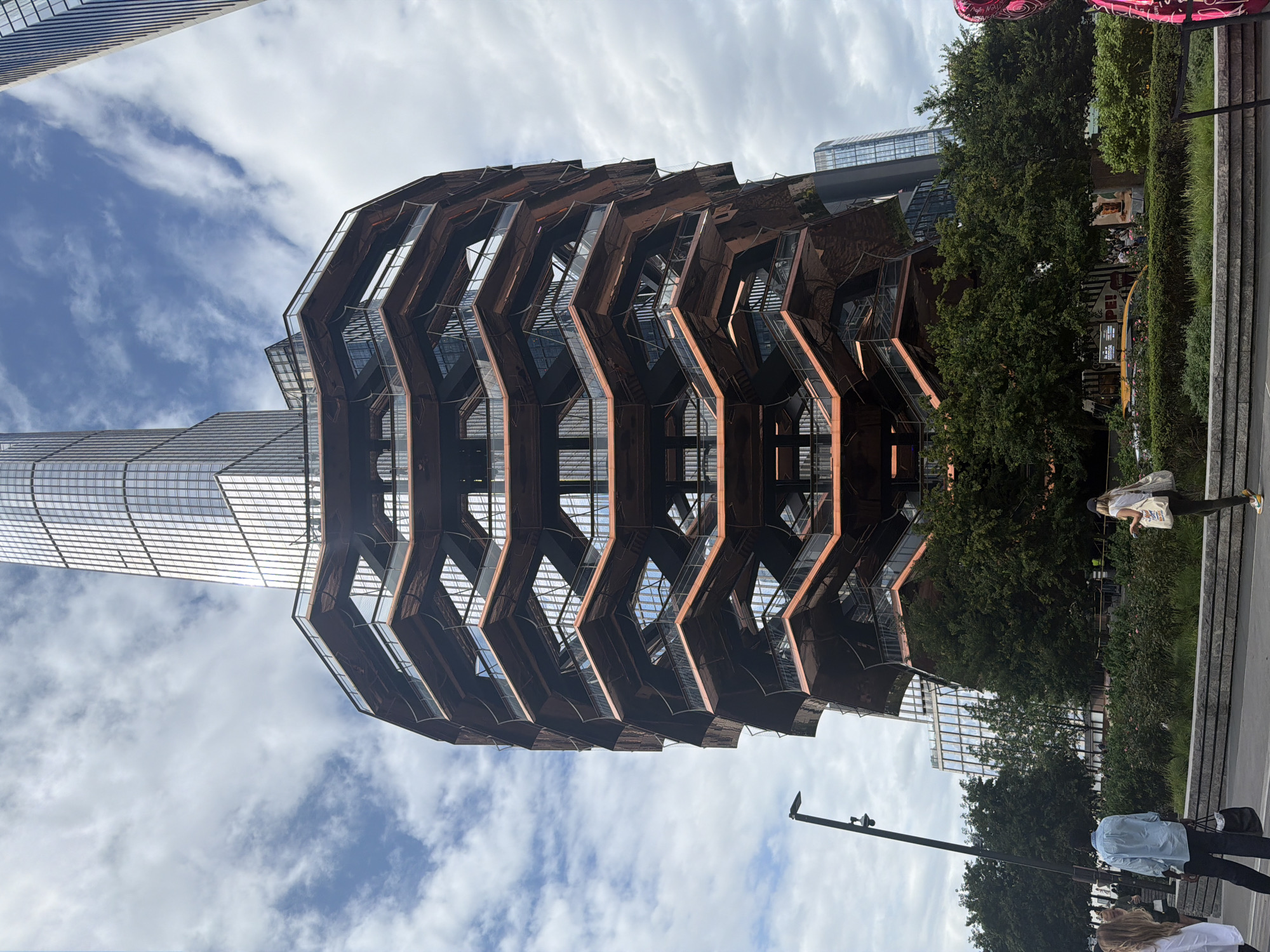 The Vessel at Hudson Yards, with a pink bear sculpture nearby