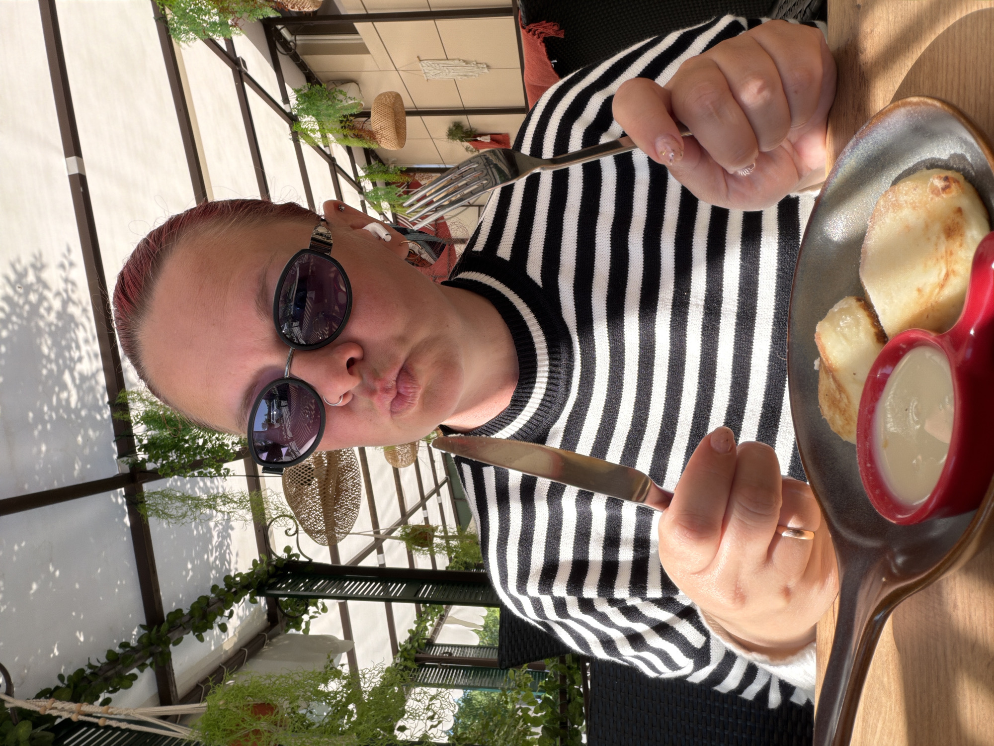 Woman dines outdoors at early morning restaurant in Chaikovsky