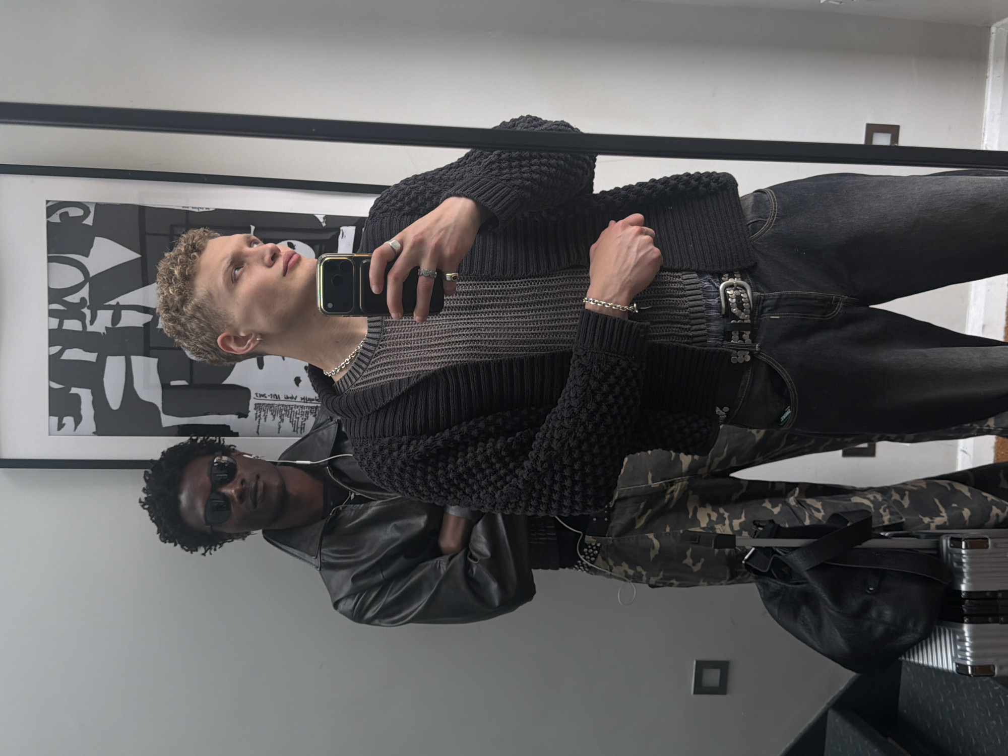 Groups take mirror selfies in London indoor space