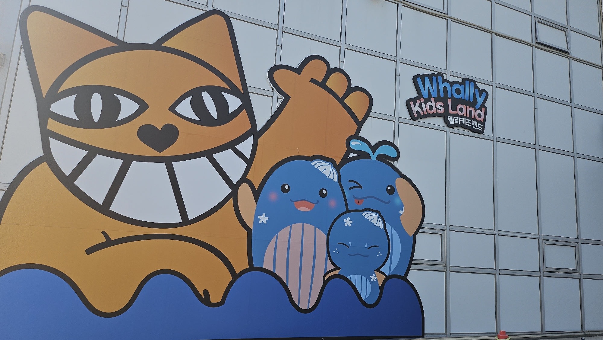 Tourist documents whale-themed attractions at Ulsan cultural village