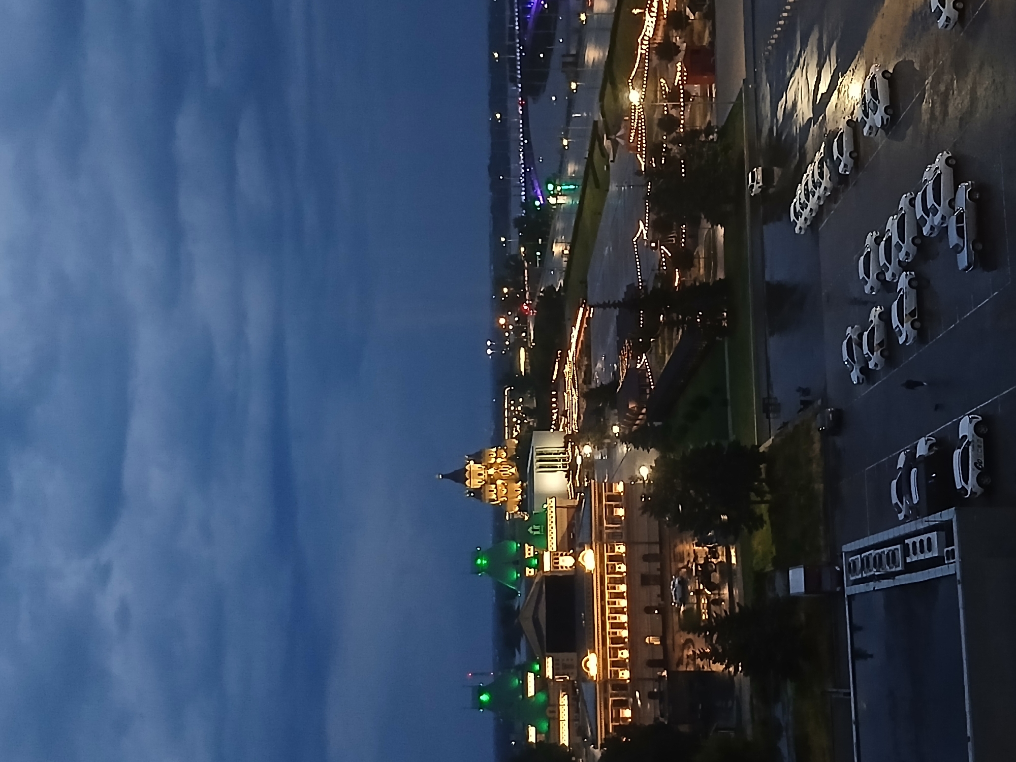 Wet parking lot and cloudy skies from above at dusk