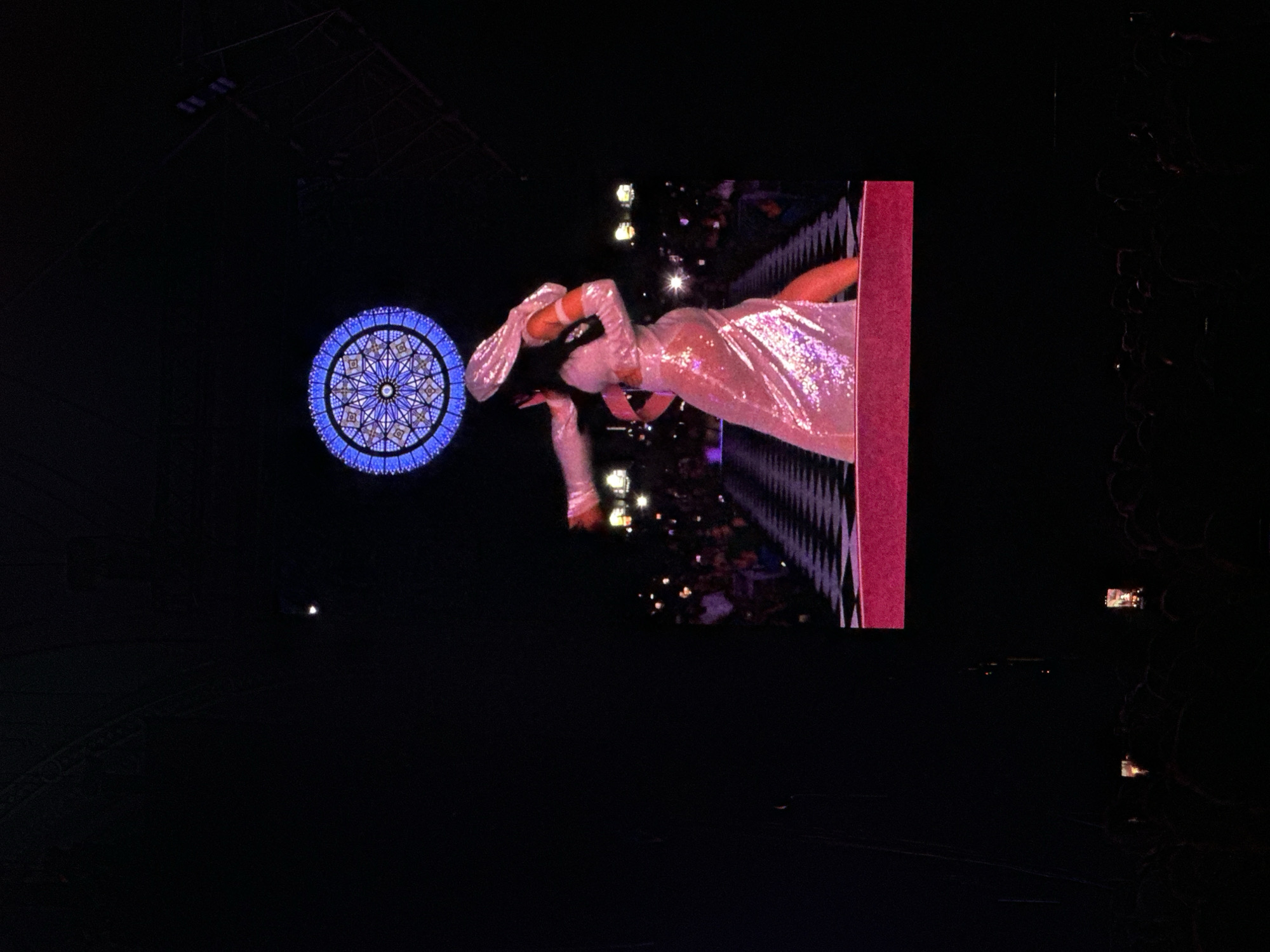 Female performer concerts in white dress at indoor venue