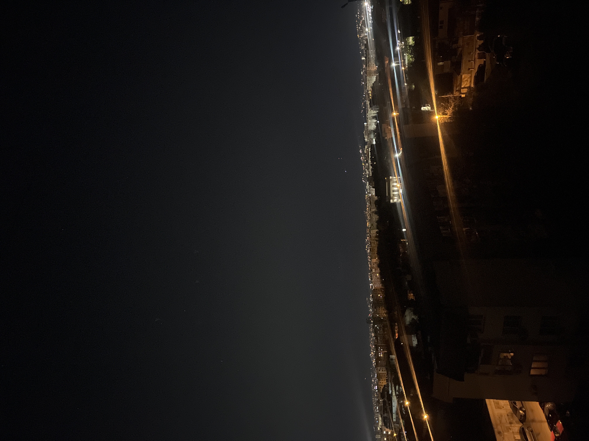 Nighttime aerial views of illuminated Sofia cityscape captured