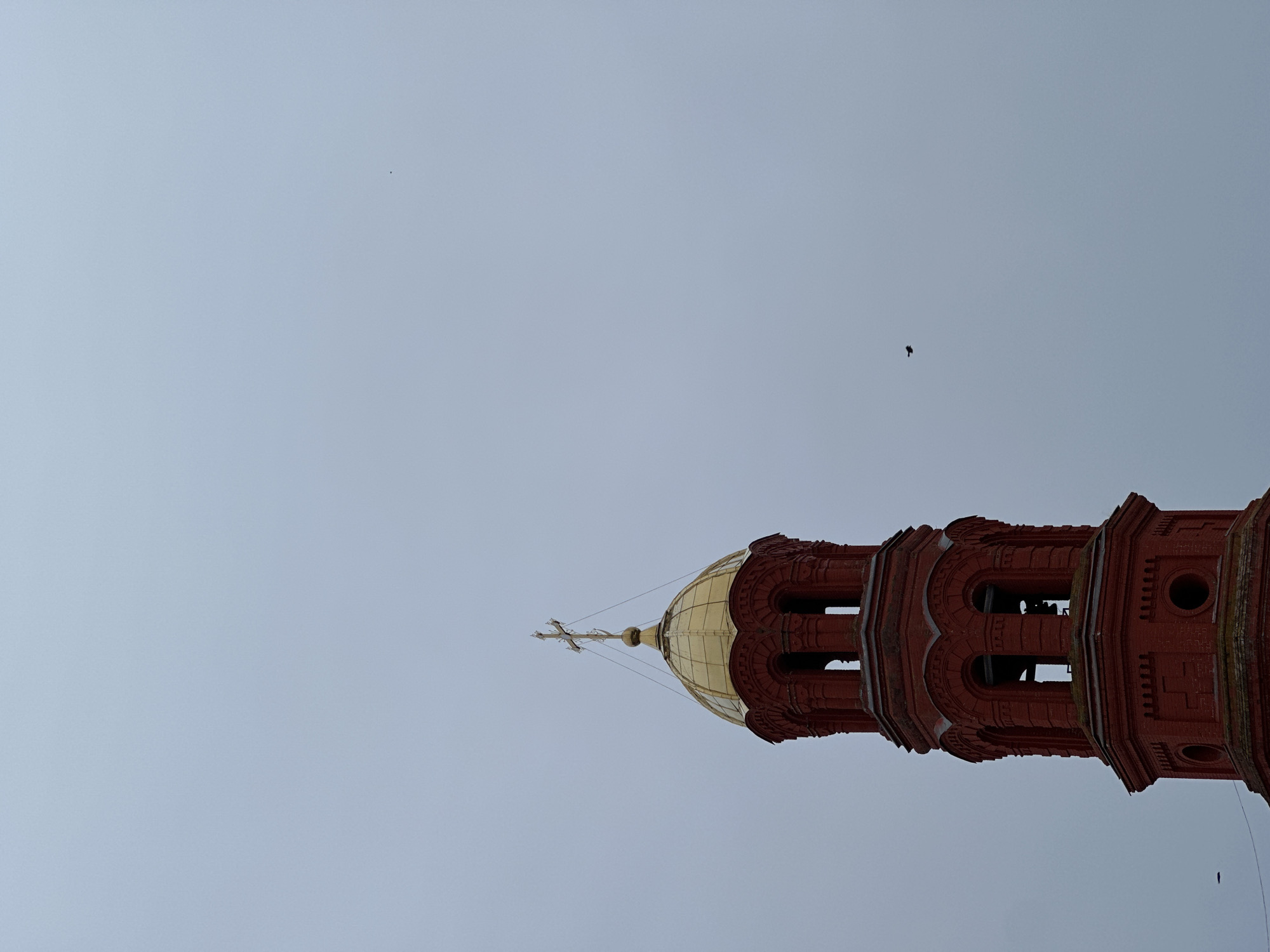 Bell tower with golden dome observed in Elovo, Russia