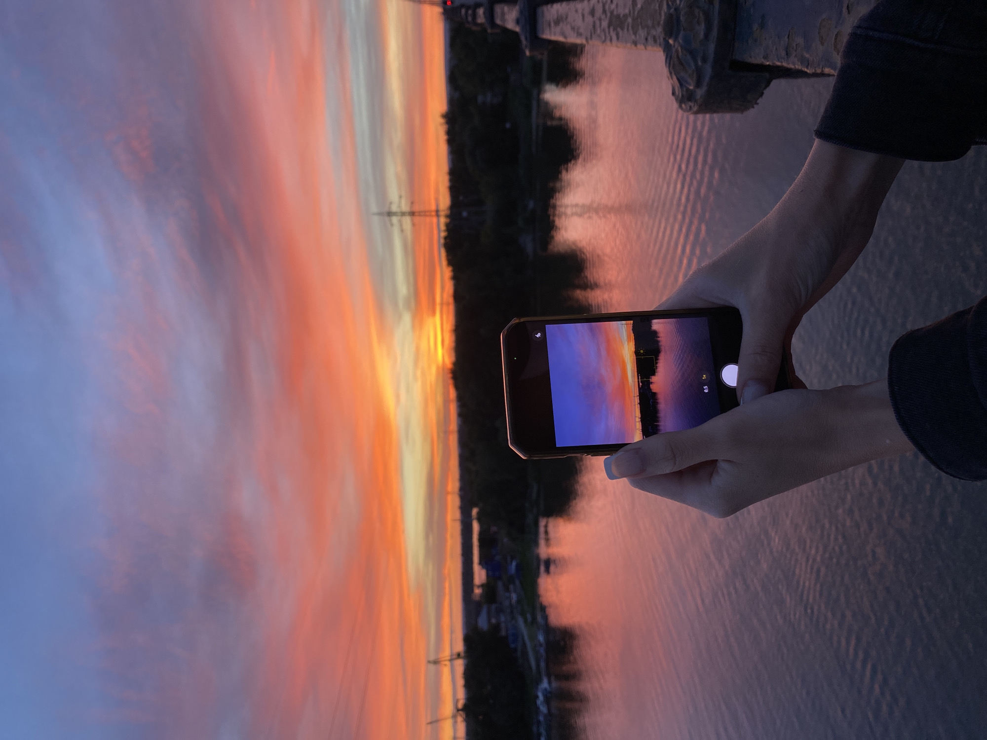 Sunset from a bridge, sky reflected on the river below