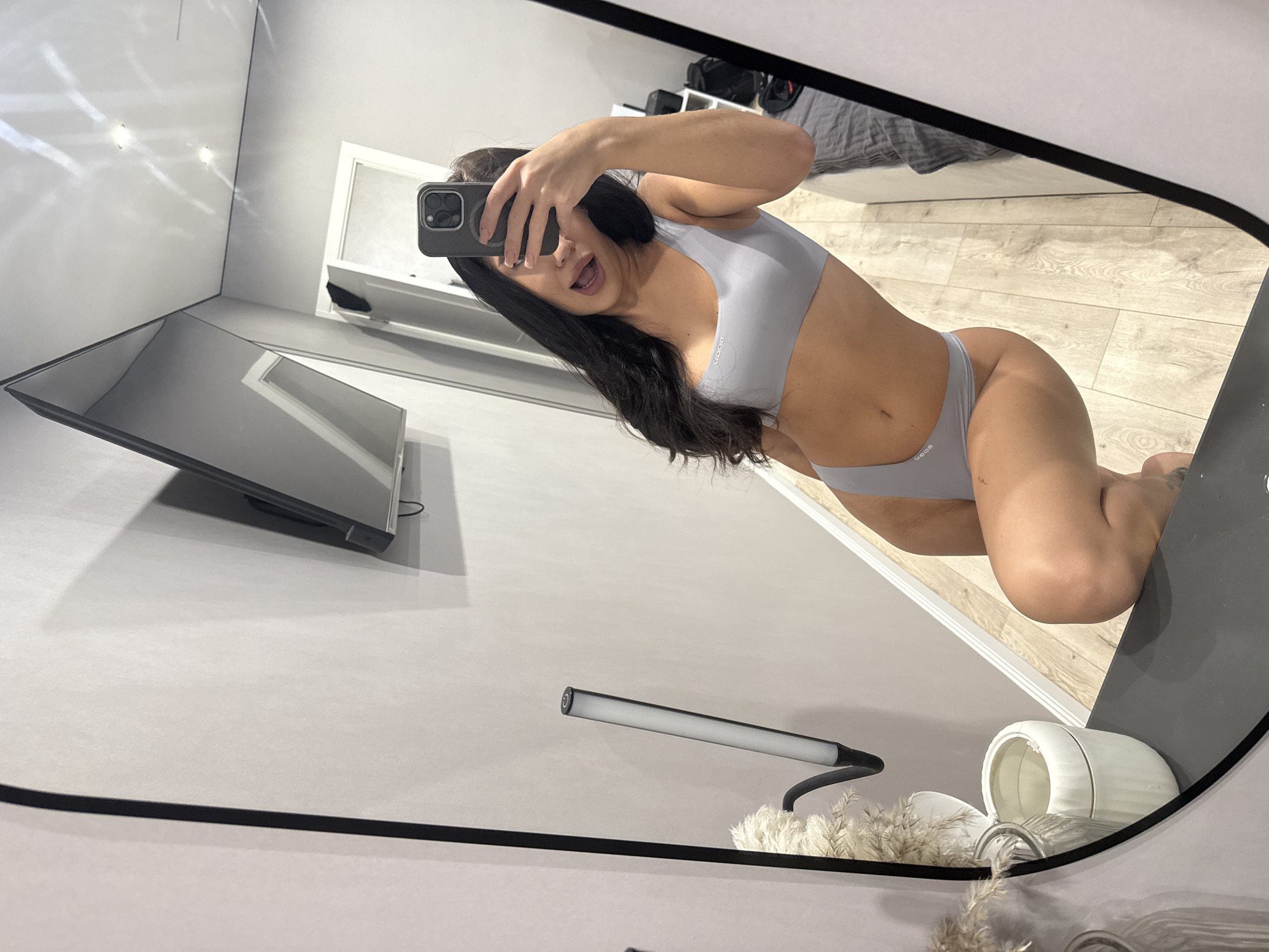 Woman takes mirror selfies in bathroom in Kazan