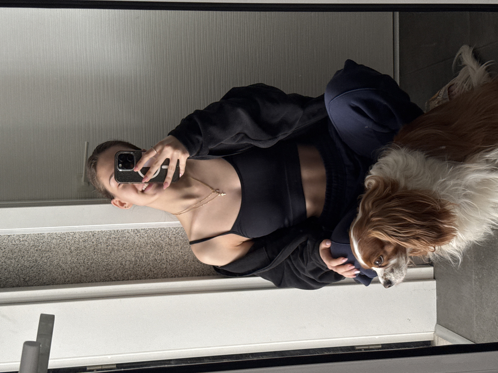 Woman takes mirror selfie in athletic wear, Sofia