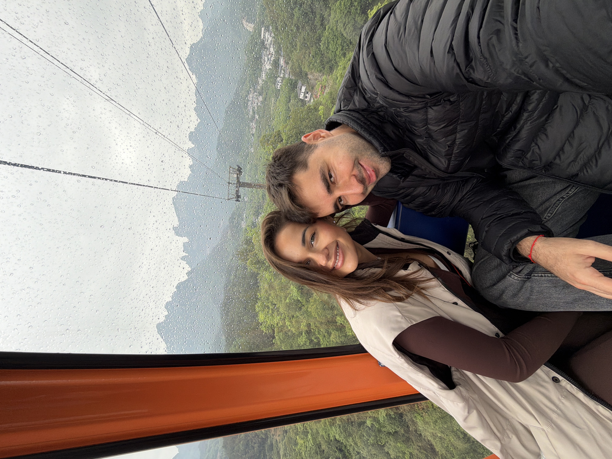 Couple rides Tianmen Mountain cable car during rainy morning