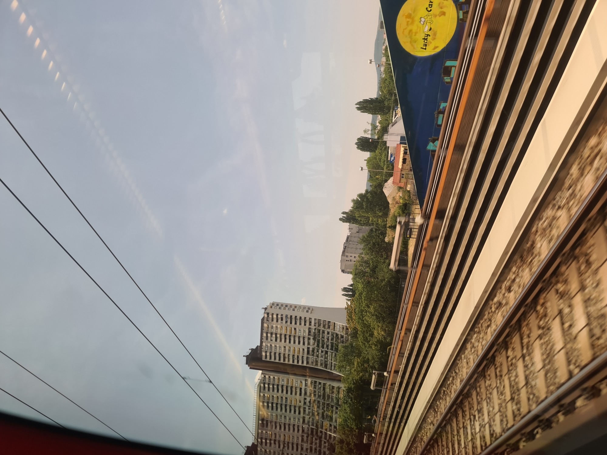 Train window view past Vienna's iconic Hundertwasser architecture
