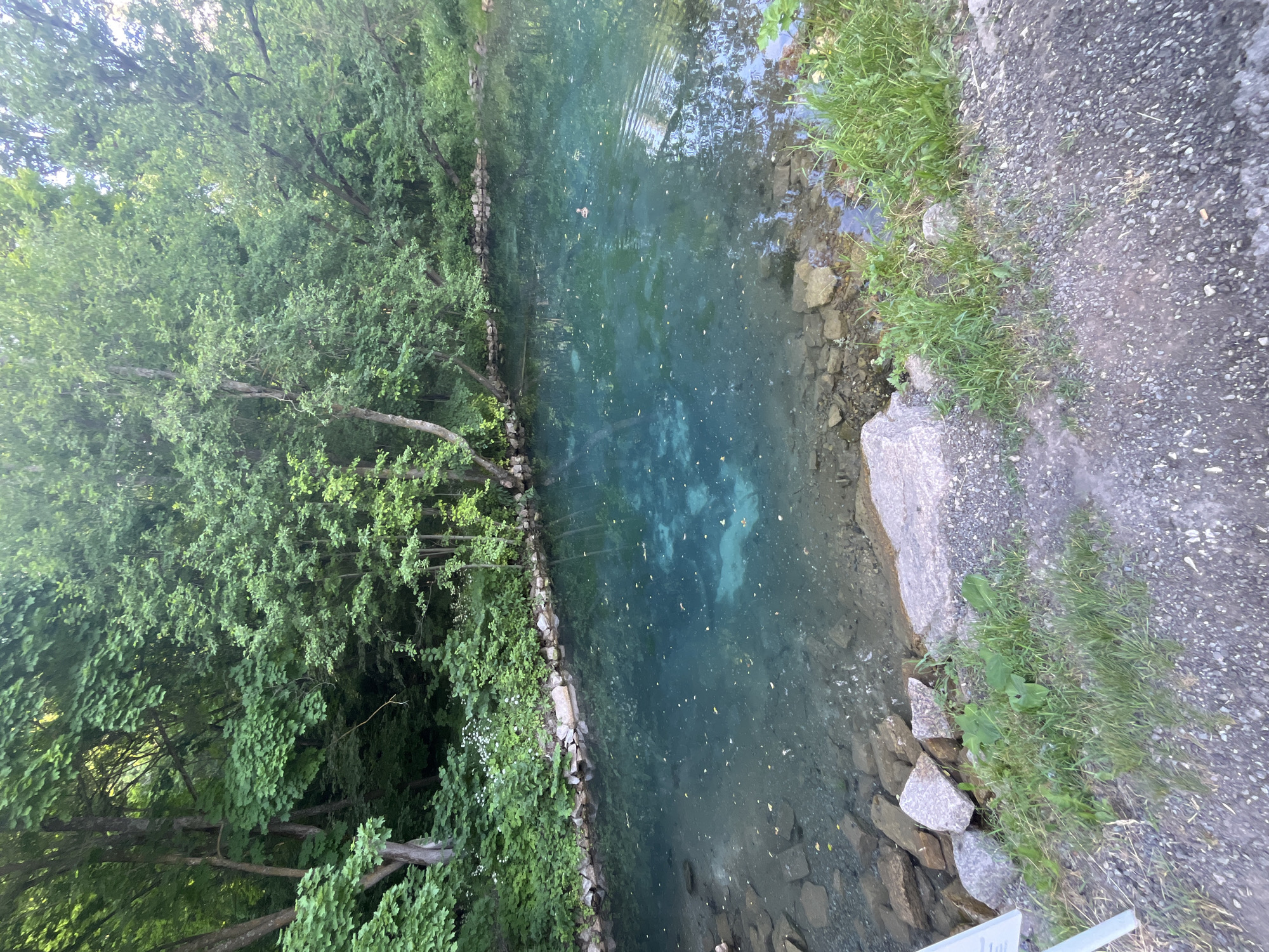Crystal-clear turquoise water surrounded by green vegetation near Kazan