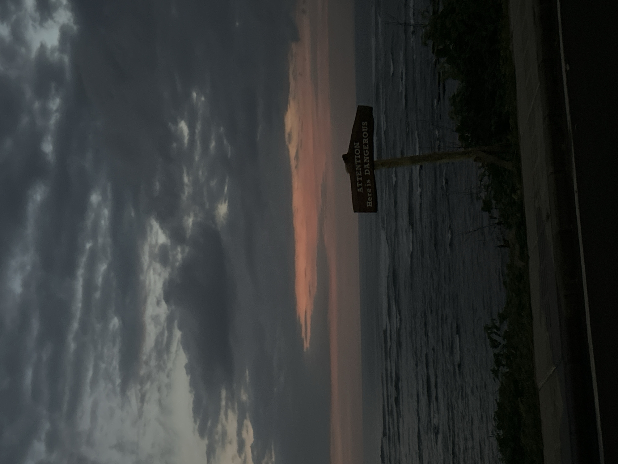Stormy weather documented along Mengwi coastline, warning signs visible