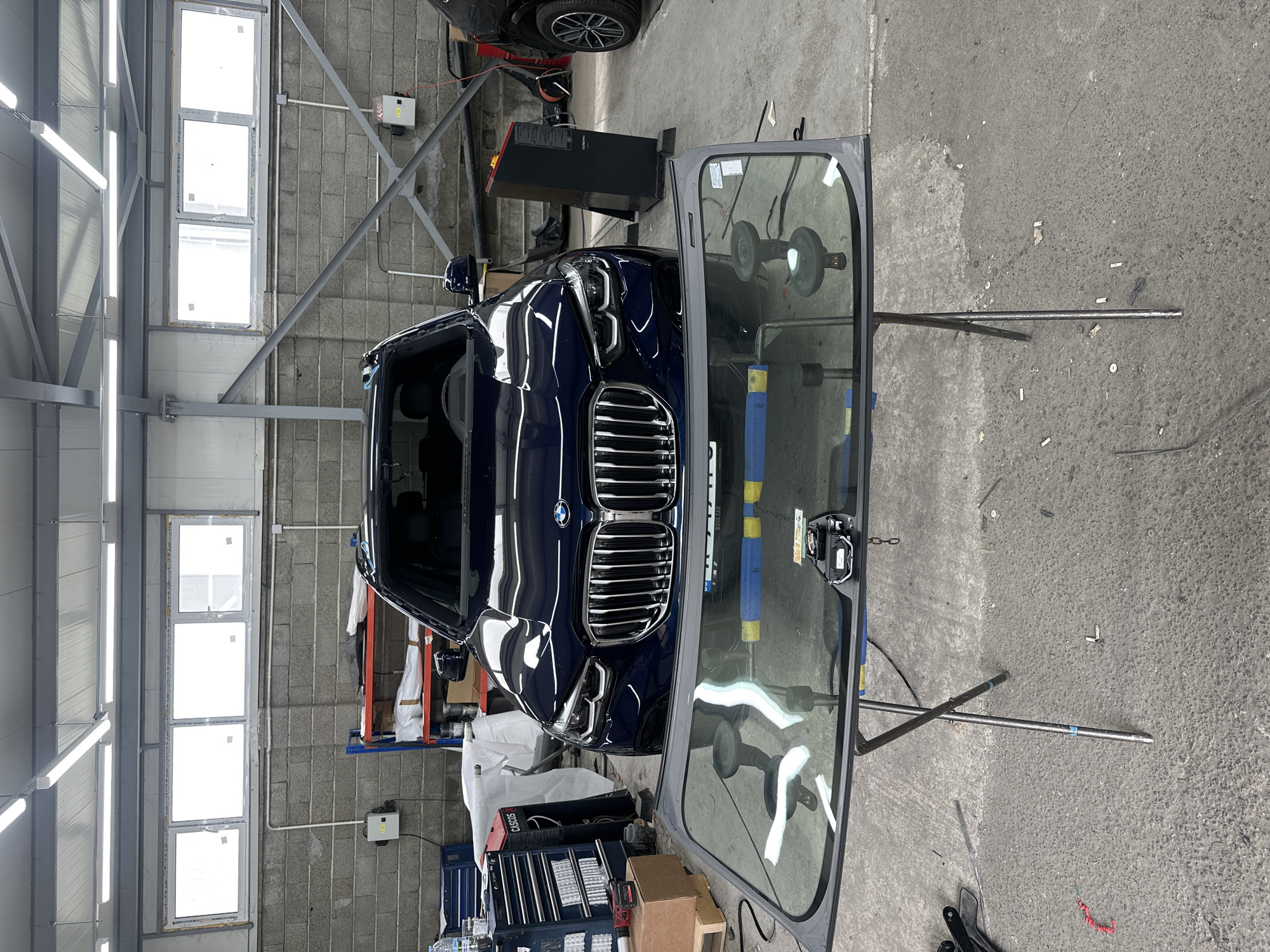 Windshield work in a garage, planes spotted overhead