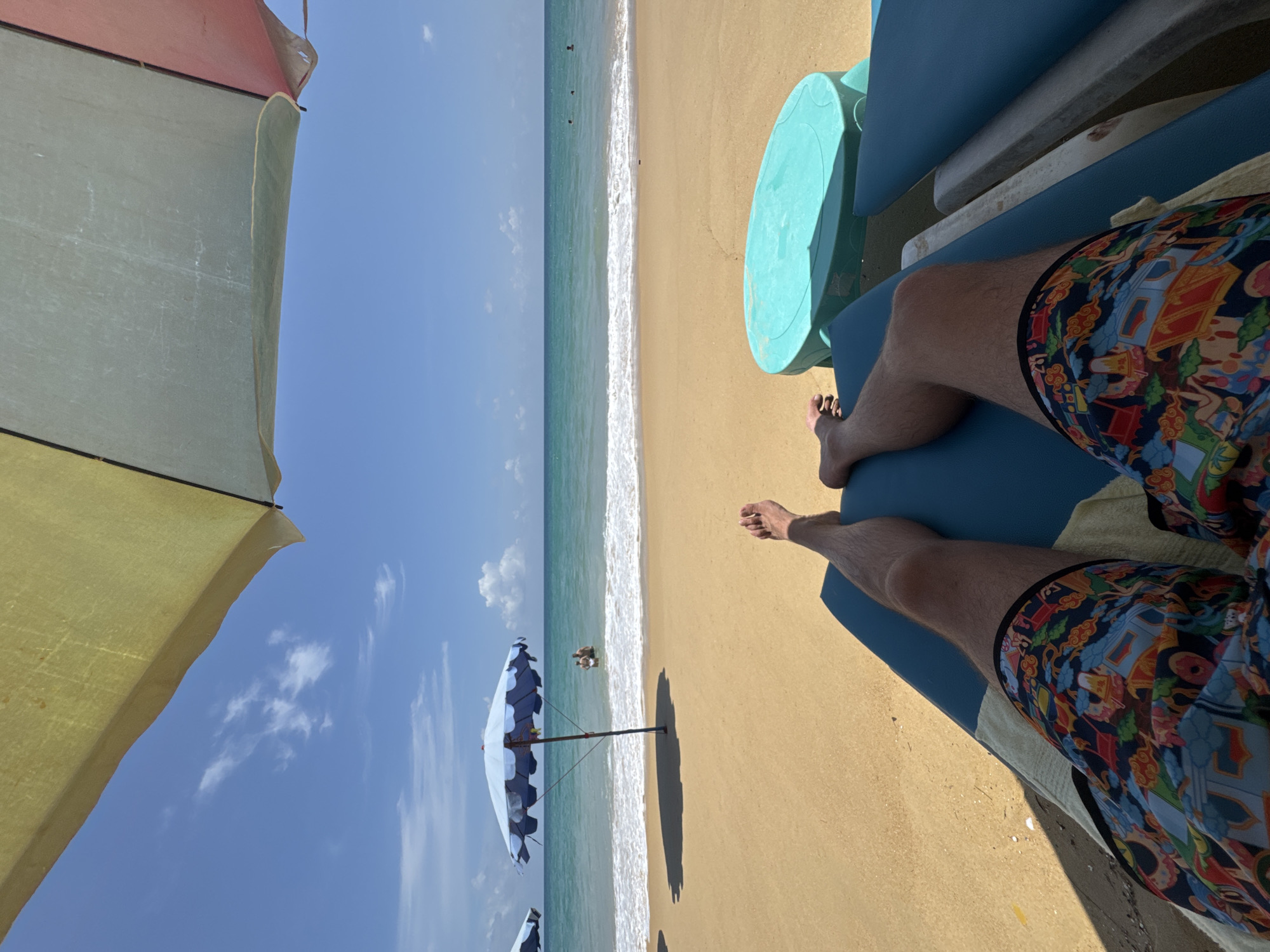 Morning beach lounging and calm waves at Karon Beach