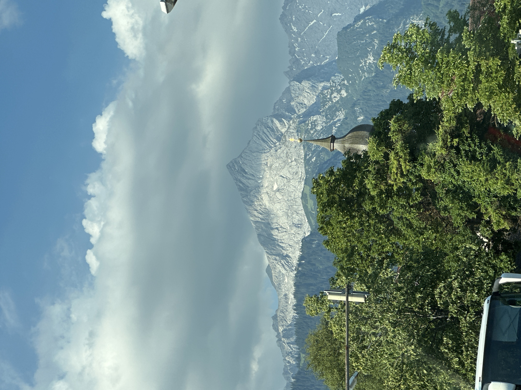 Snow-dusted Zugspitze peaks rise above Garmisch-Partenkirchen forests