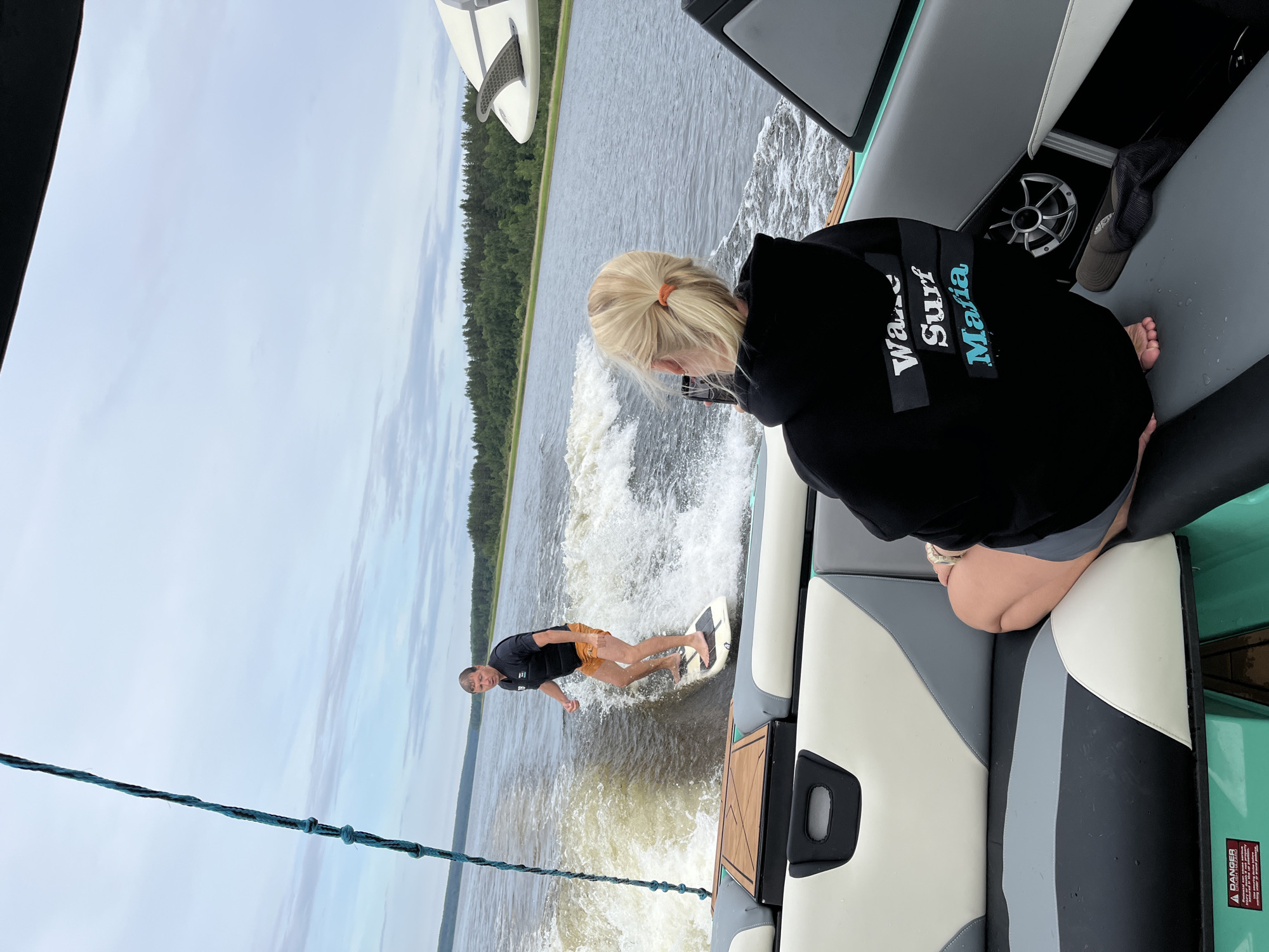 Wake surfing behind a boat on a Russian lake