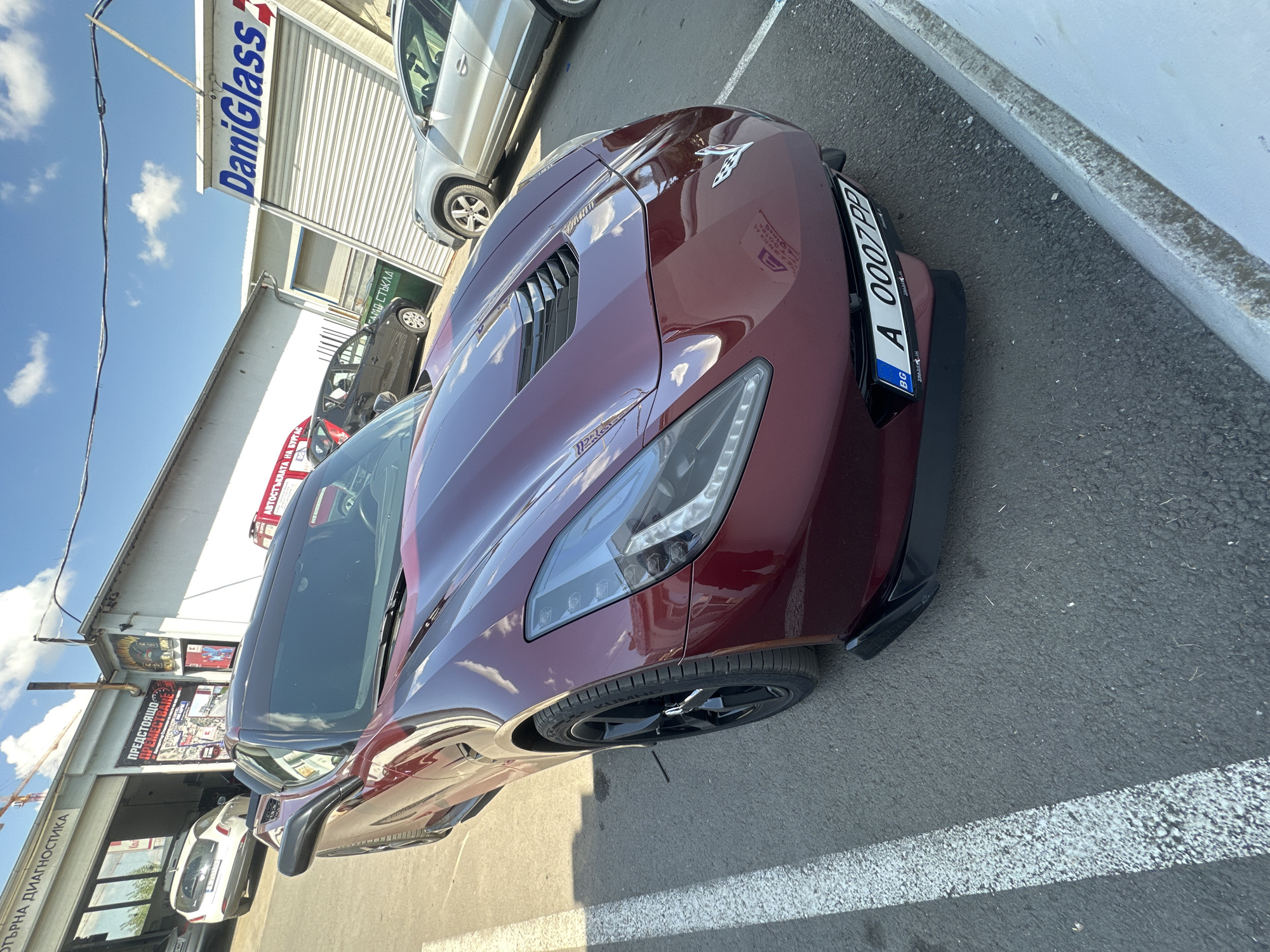 Burgundy Corvette with plate A 0007 PP parked outdoors