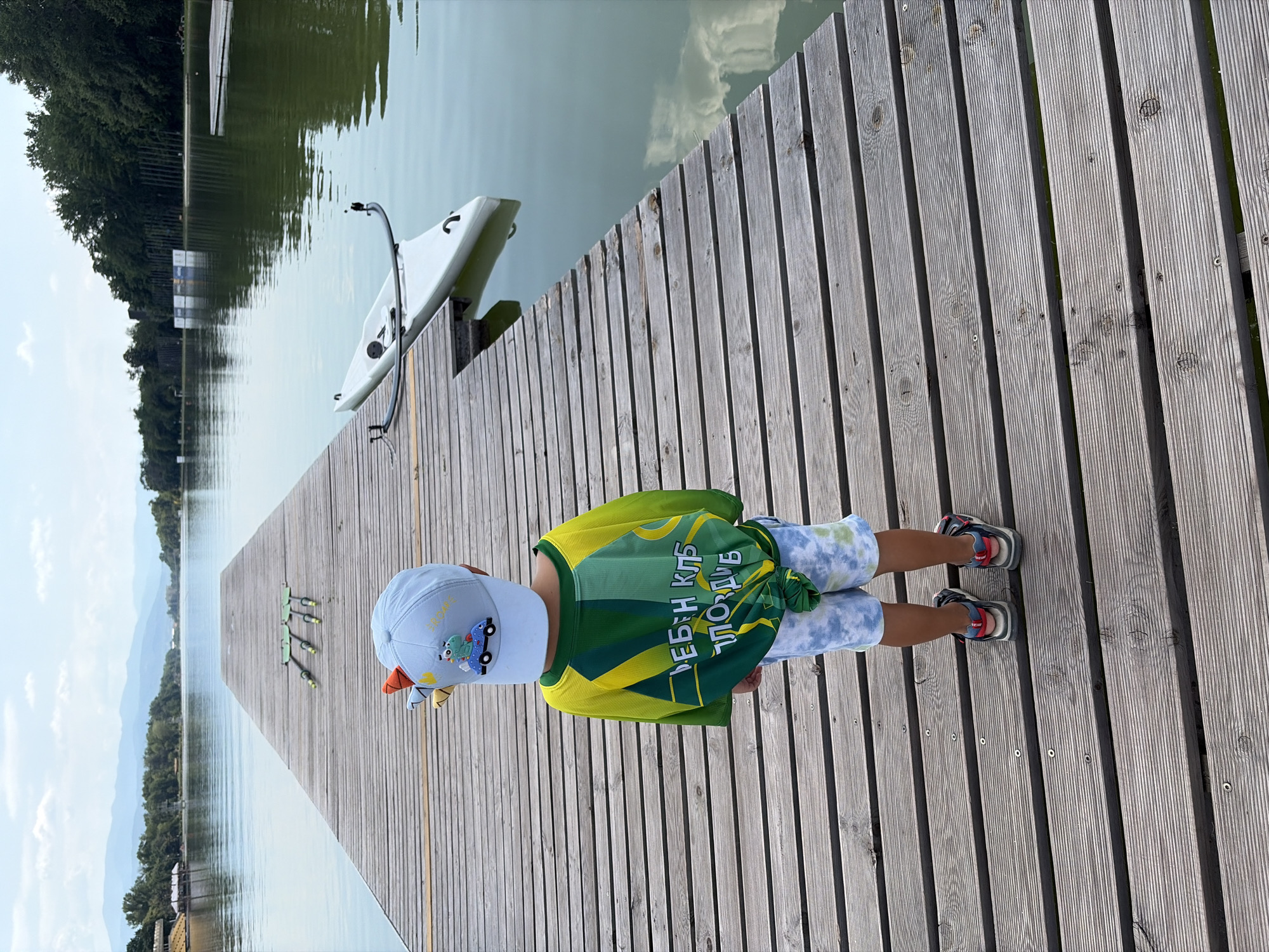 Group in matching shirts at a Plovdiv lakeside dock