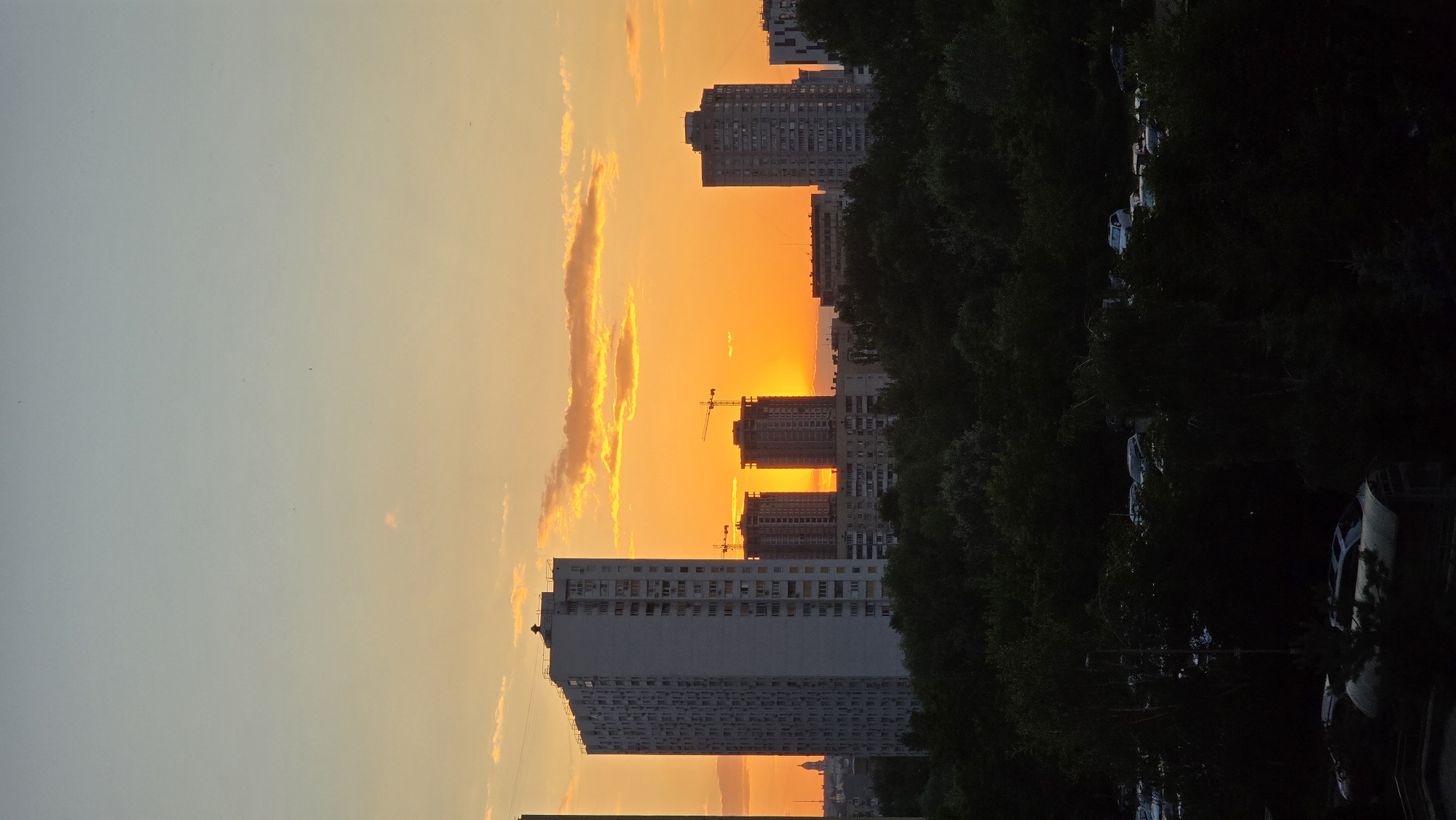 Kyiv apartment skyline glows during a summer evening sunset
