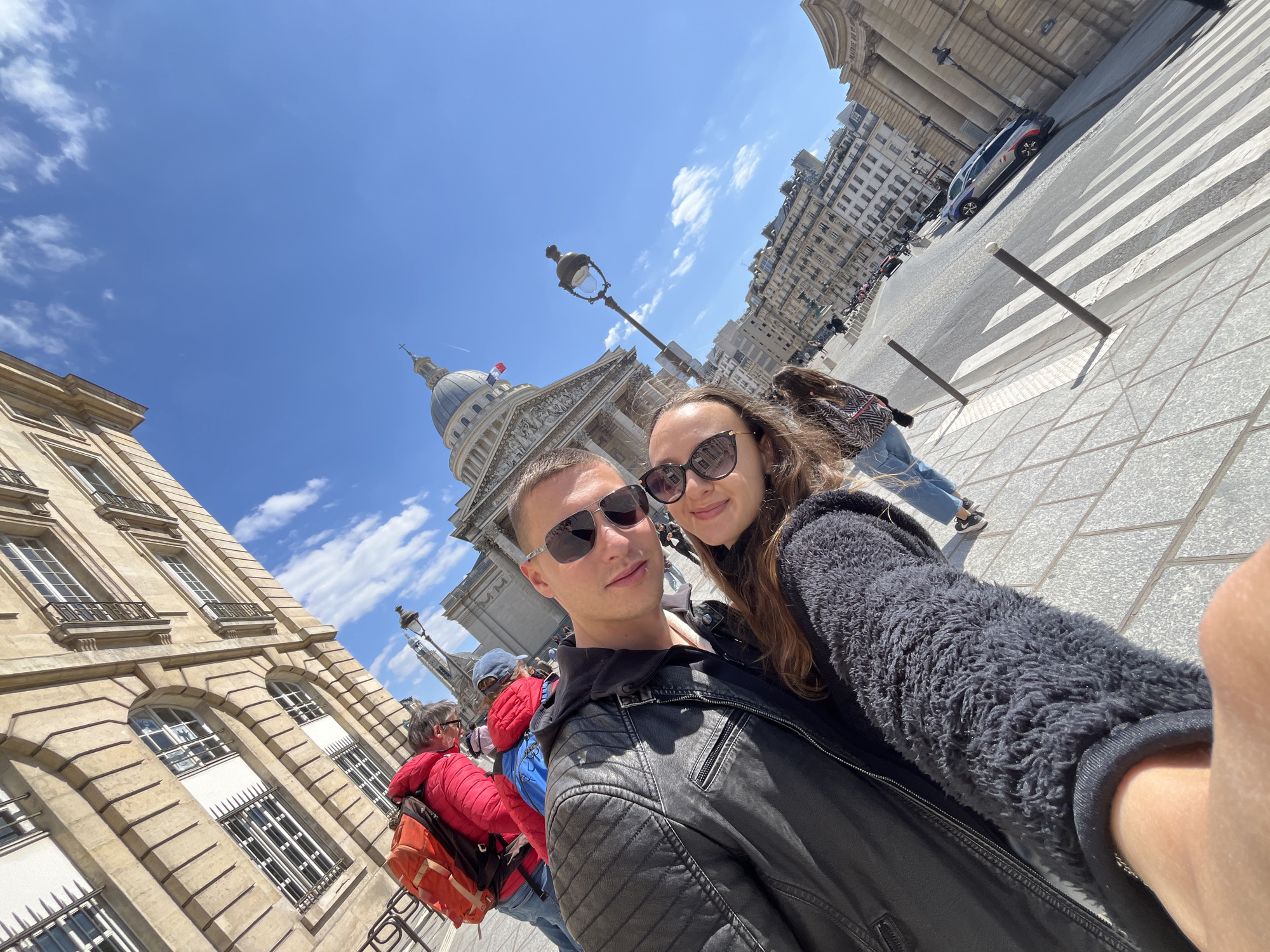 Tourists photograph Panthéon under clear Paris skies
