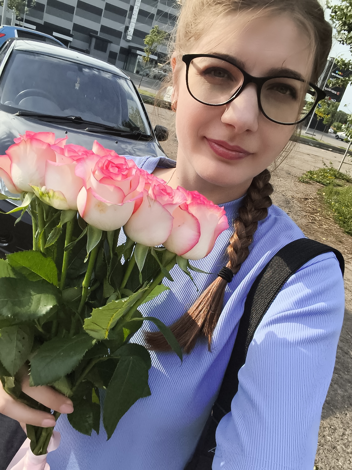 Bouquet of roses outside a modern building in Voronezh
