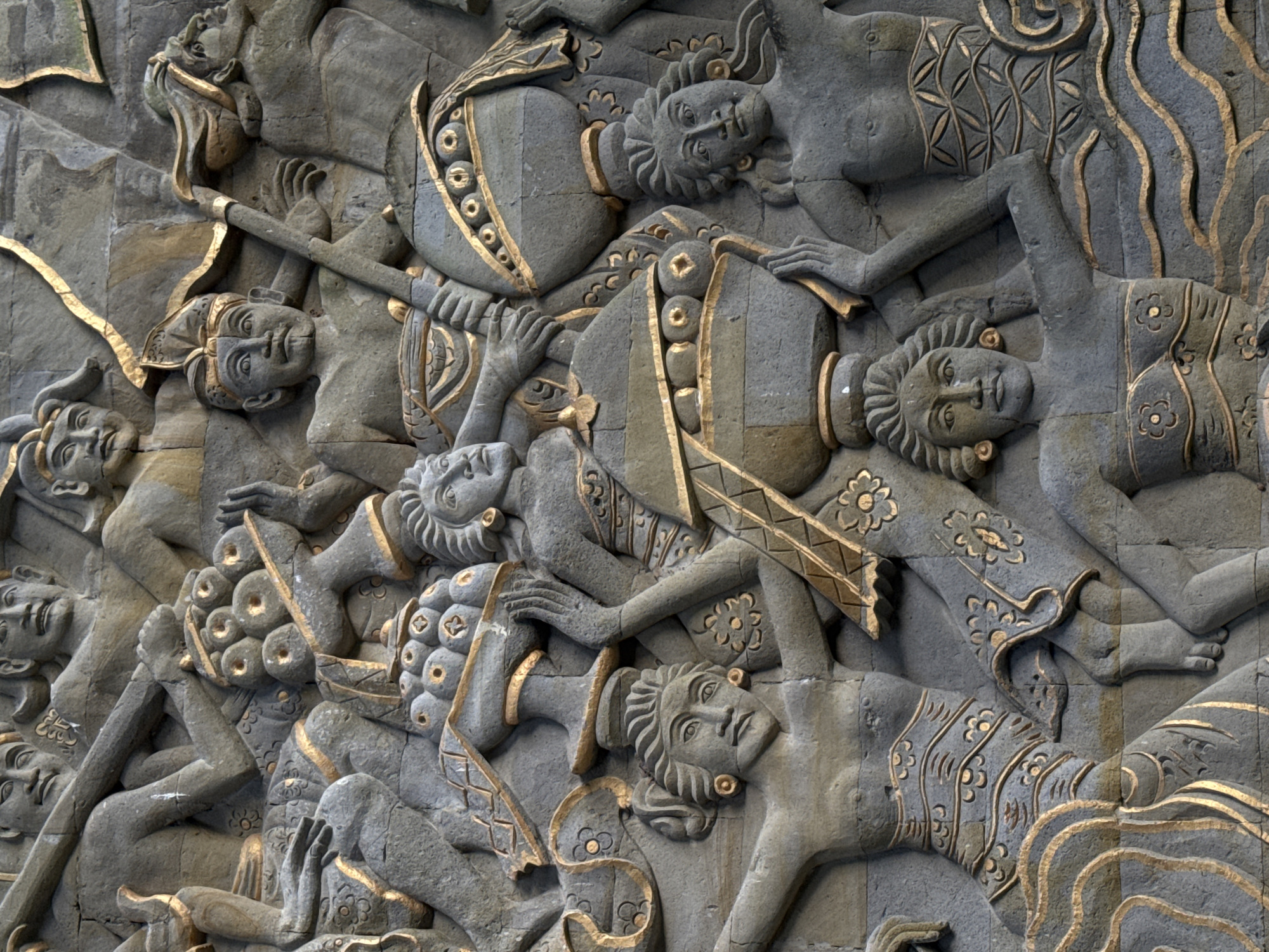 Tourist explores Balinese resort grounds with traditional sculptures and gardens